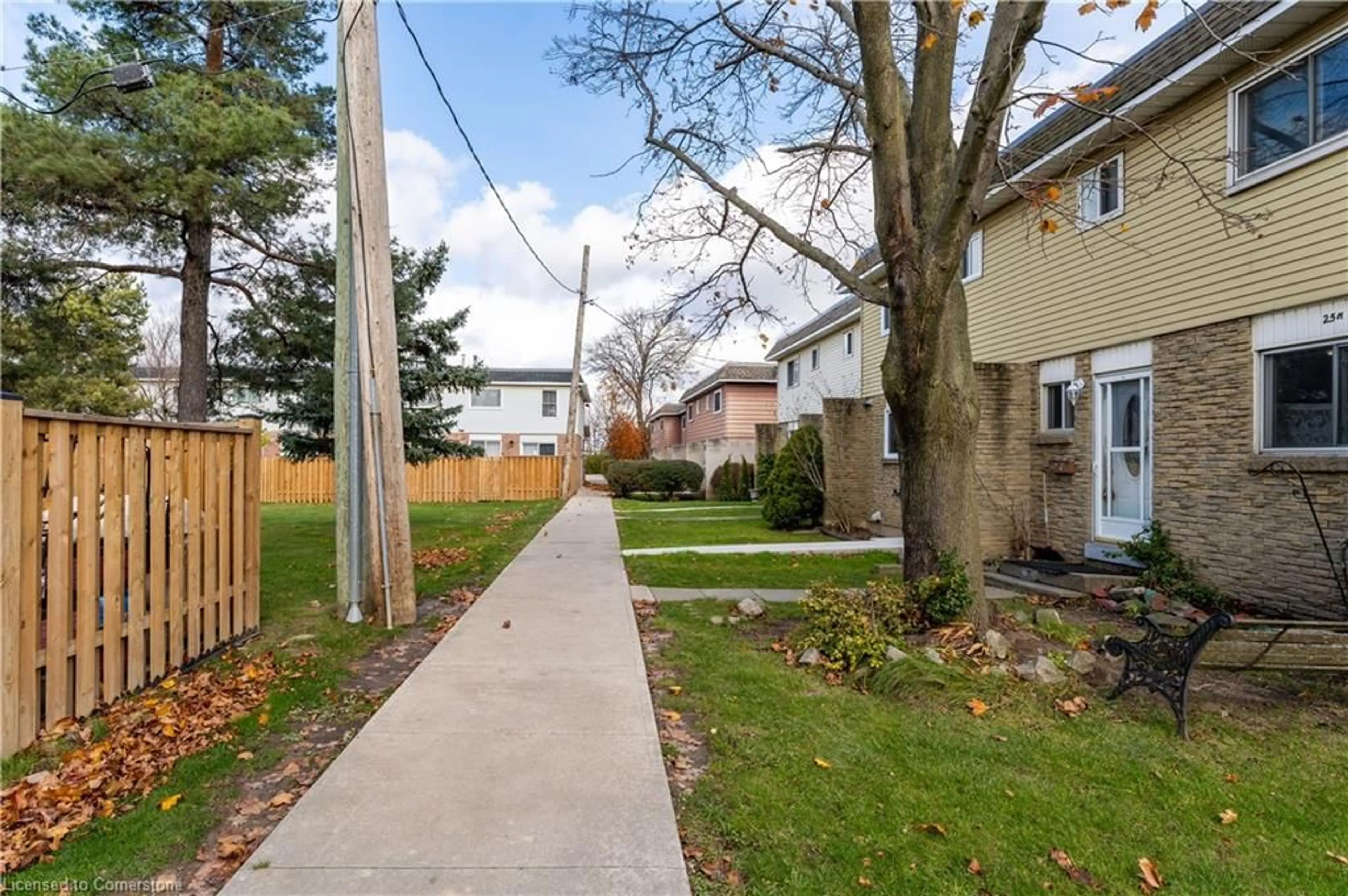 A pic from exterior of the house or condo, the fenced backyard for 25 Bryna Ave #M, Hamilton Ontario L9A 4W9