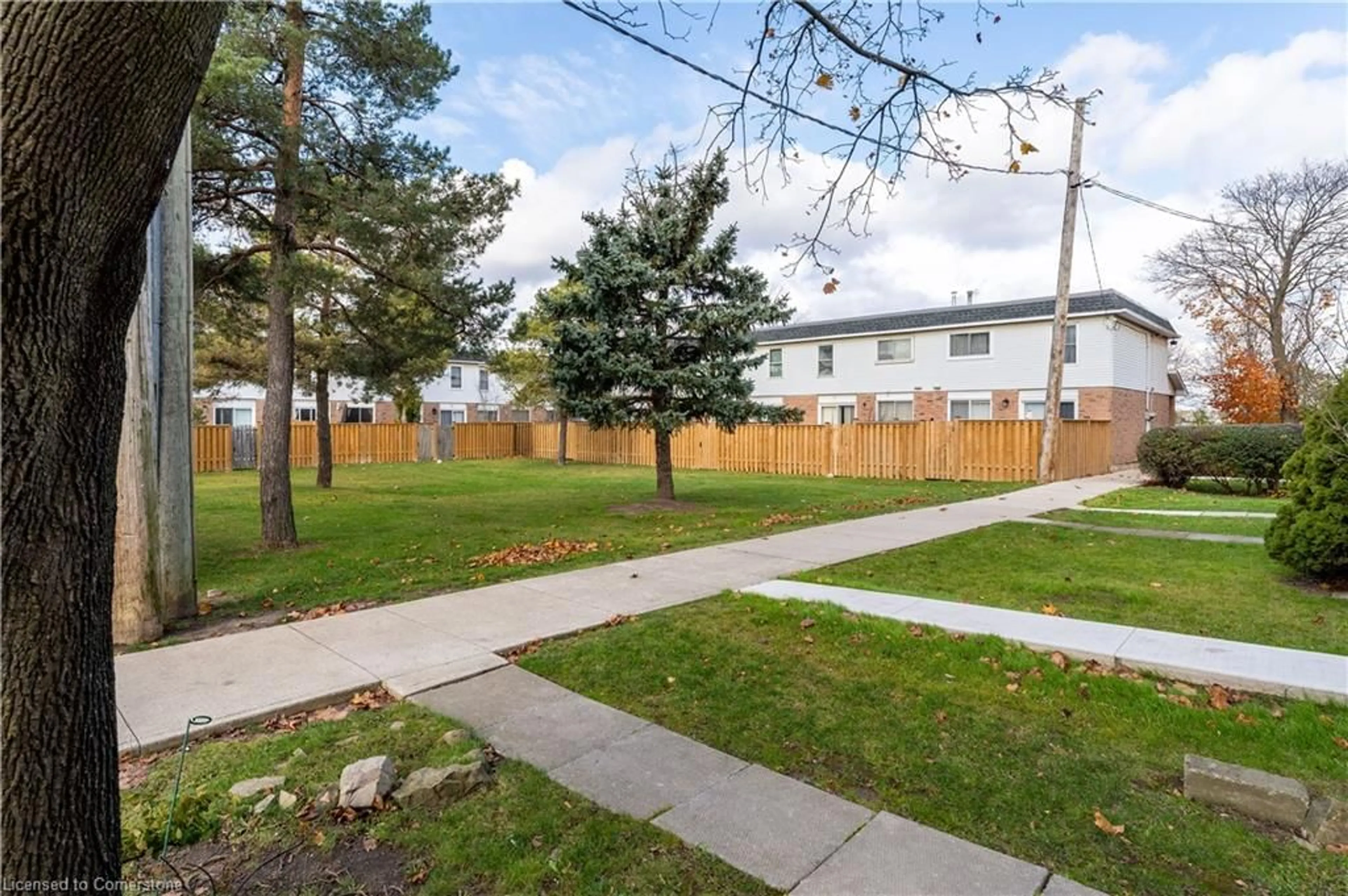 A pic from exterior of the house or condo, the fenced backyard for 25 Bryna Ave #M, Hamilton Ontario L9A 4W9