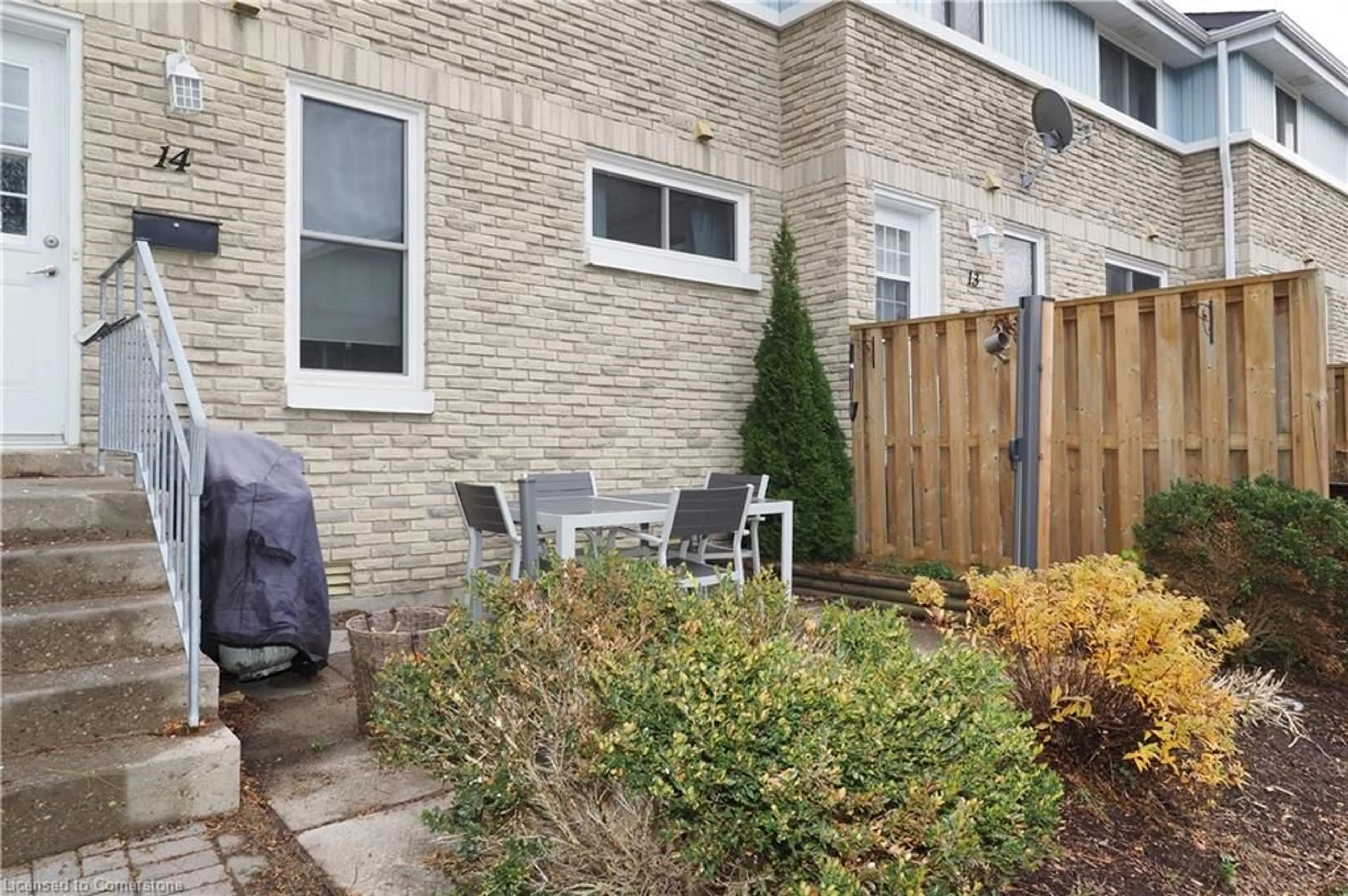 A pic from exterior of the house or condo, the fenced backyard for 35 Breckenridge Dr #14, Kitchener Ontario N2B 3H5