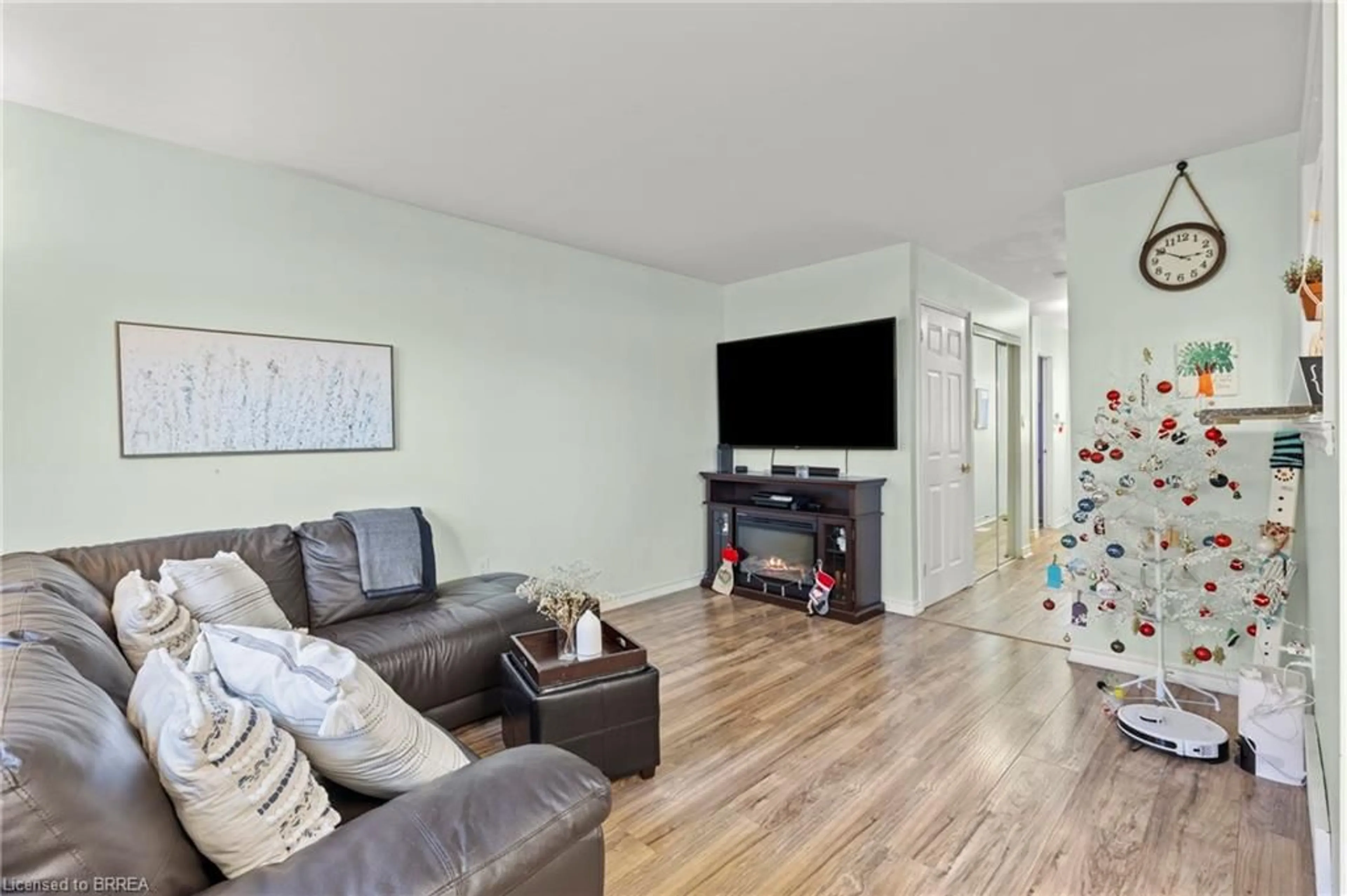 Living room with furniture, wood/laminate floor for 100 Quigley Rd #126, Hamilton Ontario L8K 6J1