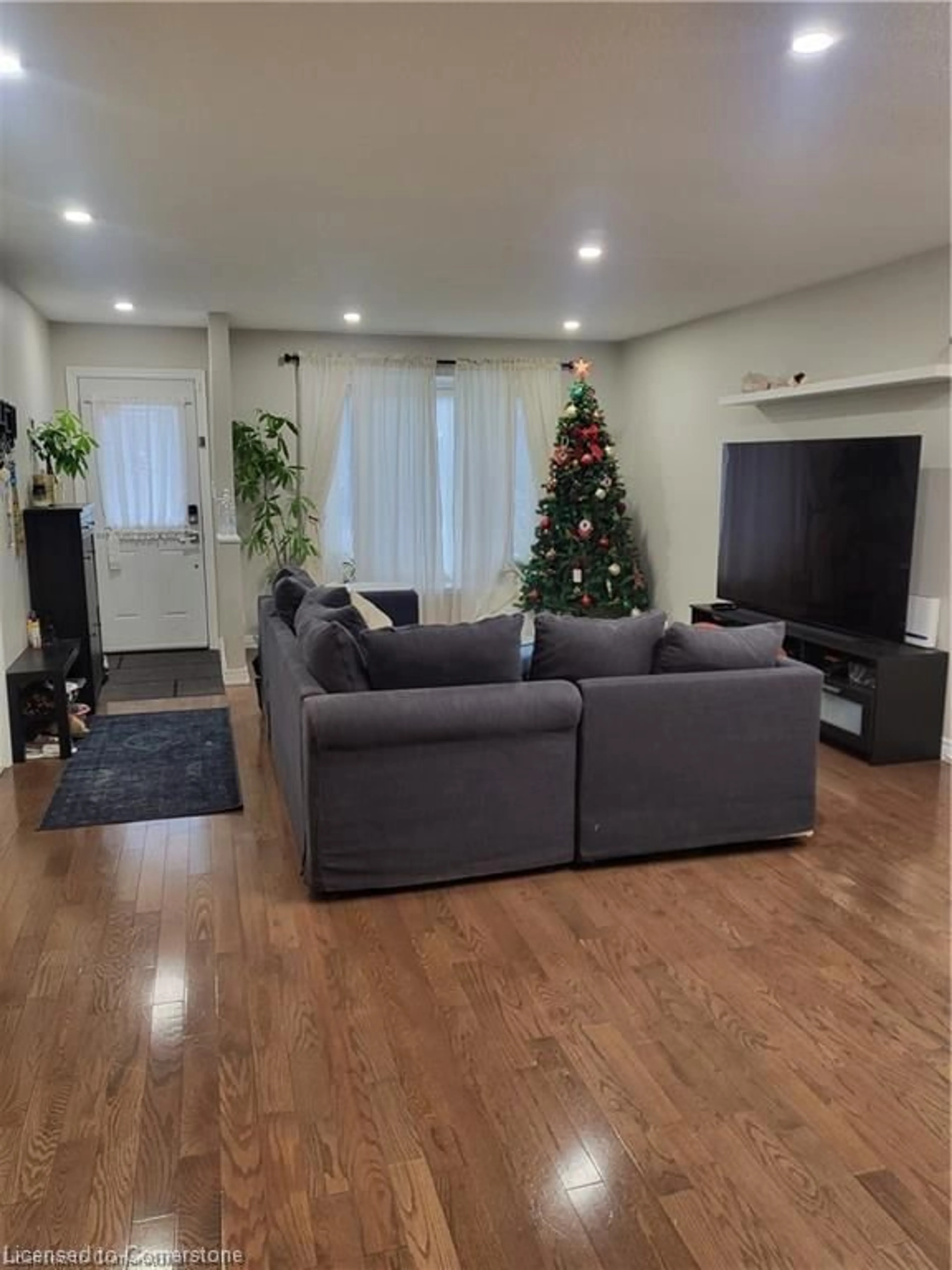 Living room with furniture, wood/laminate floor for 18 Rosewell St, Hamilton Ontario L8W 2L1