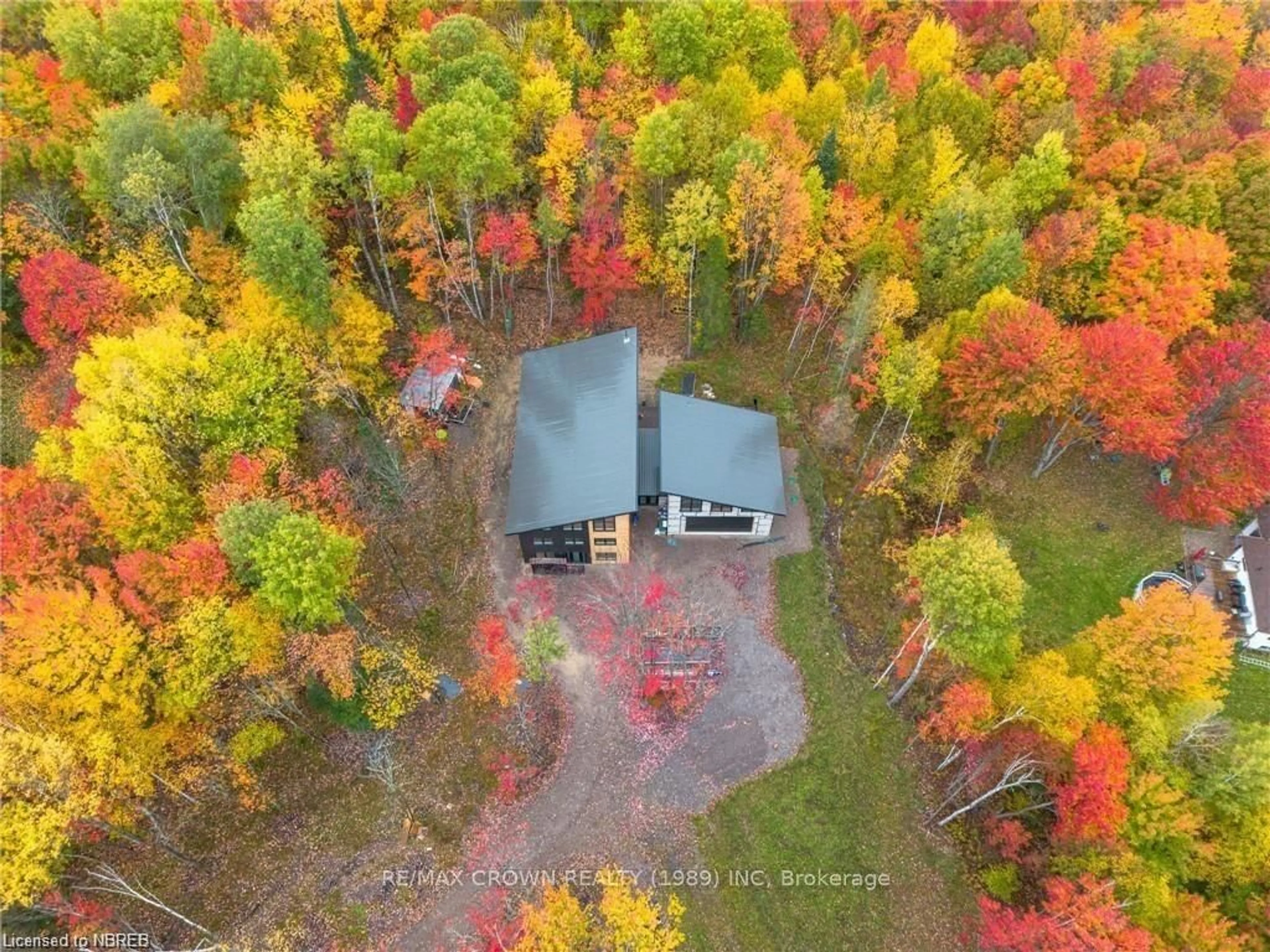 A pic from outside/outdoor area/front of a property/back of a property/a pic from drone, forest/trees view for 24 Sun Valley Way, Powassan Ontario P0H 1Z0