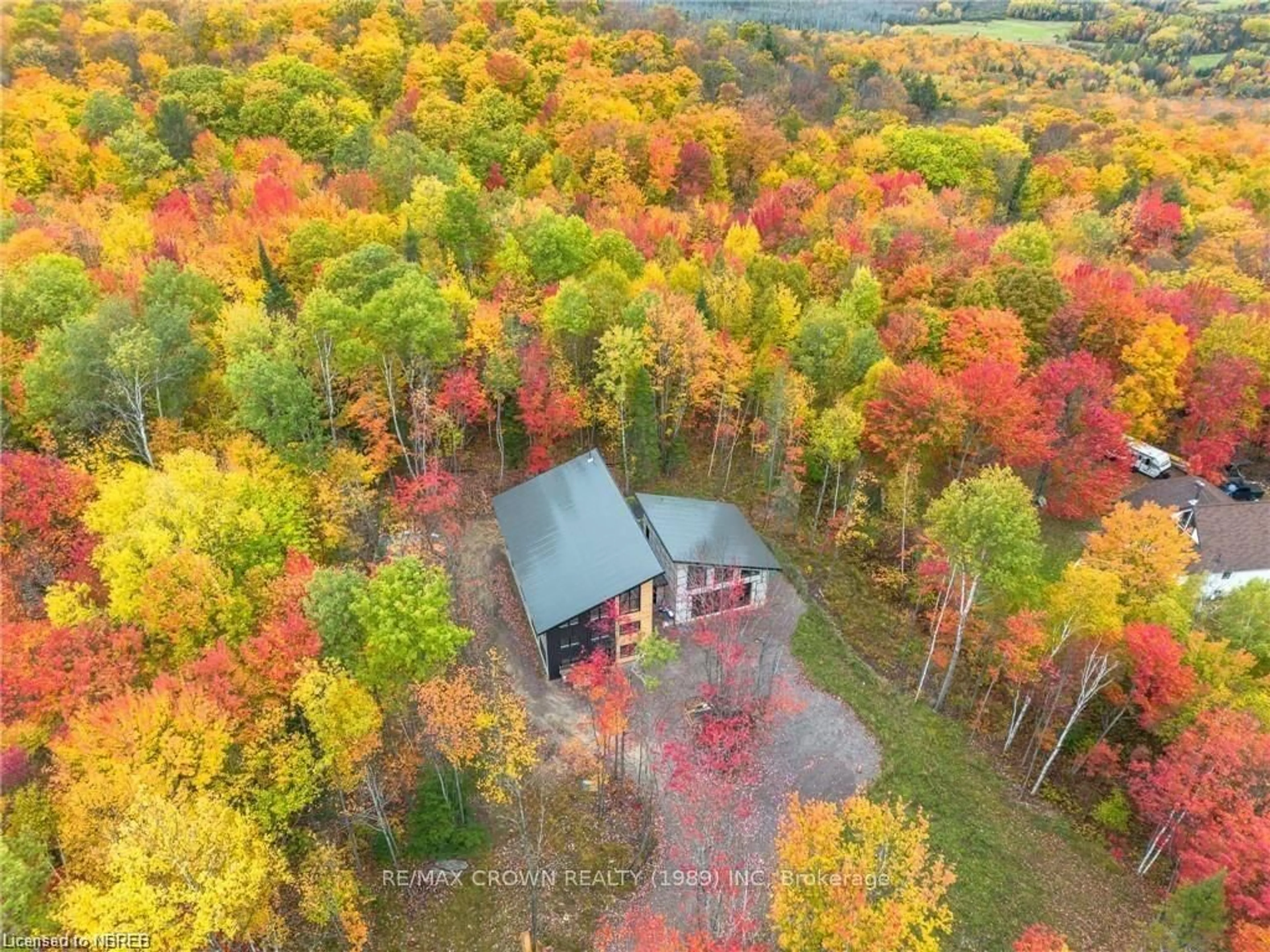 A pic from outside/outdoor area/front of a property/back of a property/a pic from drone, forest/trees view for 24 Sun Valley Way, Powassan Ontario P0H 1Z0