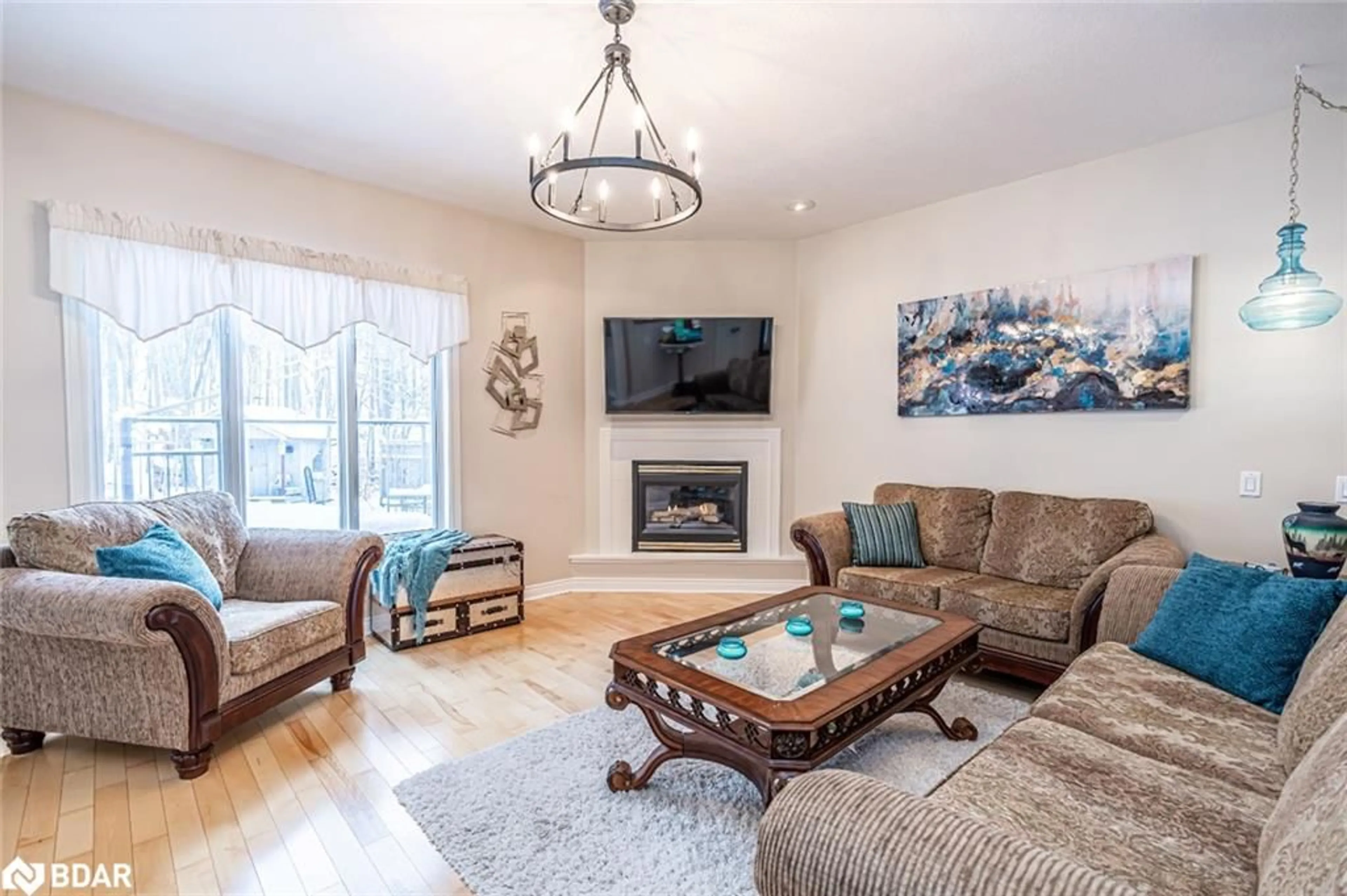 Living room with furniture, wood/laminate floor for 128 Wildwood Trail, Barrie Ontario L4N 7Z6