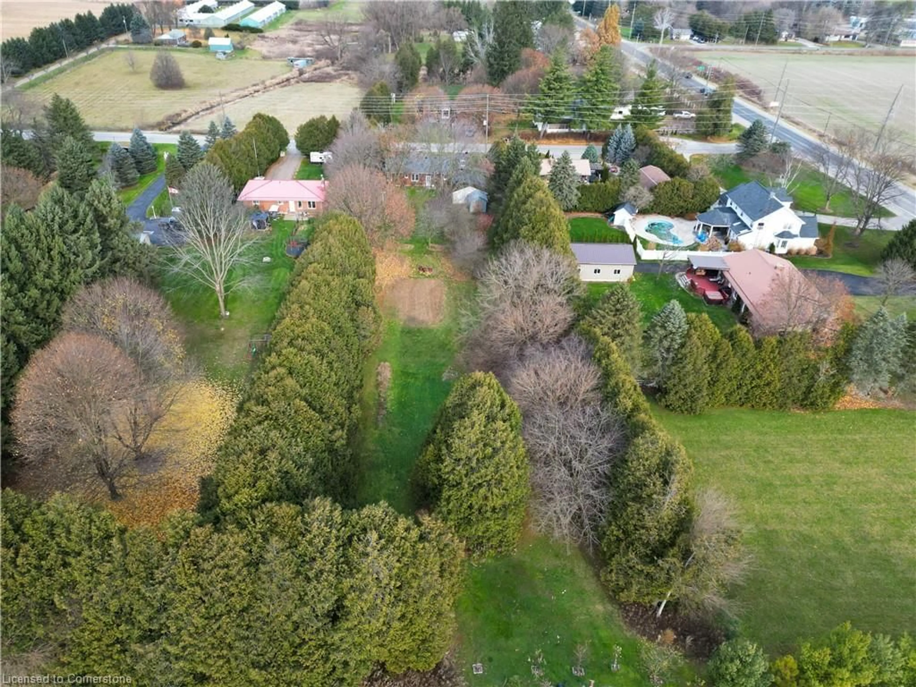 A pic from outside/outdoor area/front of a property/back of a property/a pic from drone, forest/trees view for 10 Thirteenth Street West, Simcoe Ontario N3Y 4K3