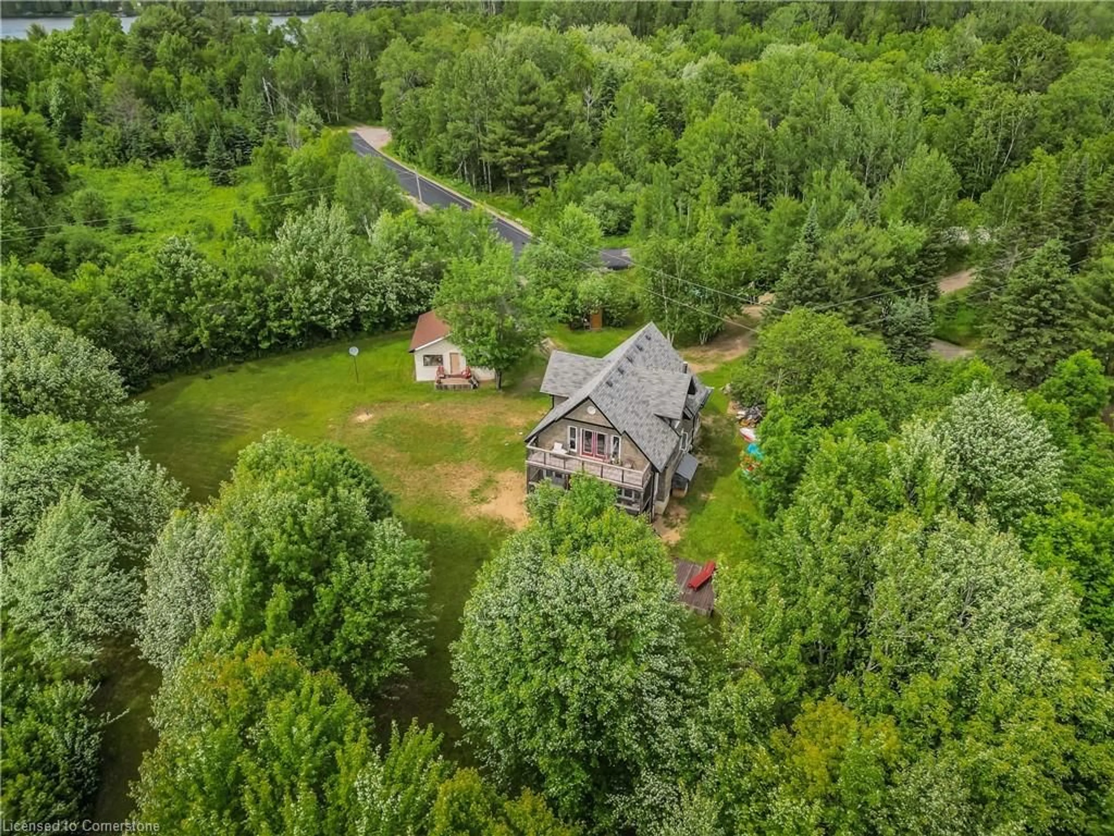 A pic from outside/outdoor area/front of a property/back of a property/a pic from drone, forest/trees view for 5 Bridge Rd, Magnetawan Ontario P0A 1P0