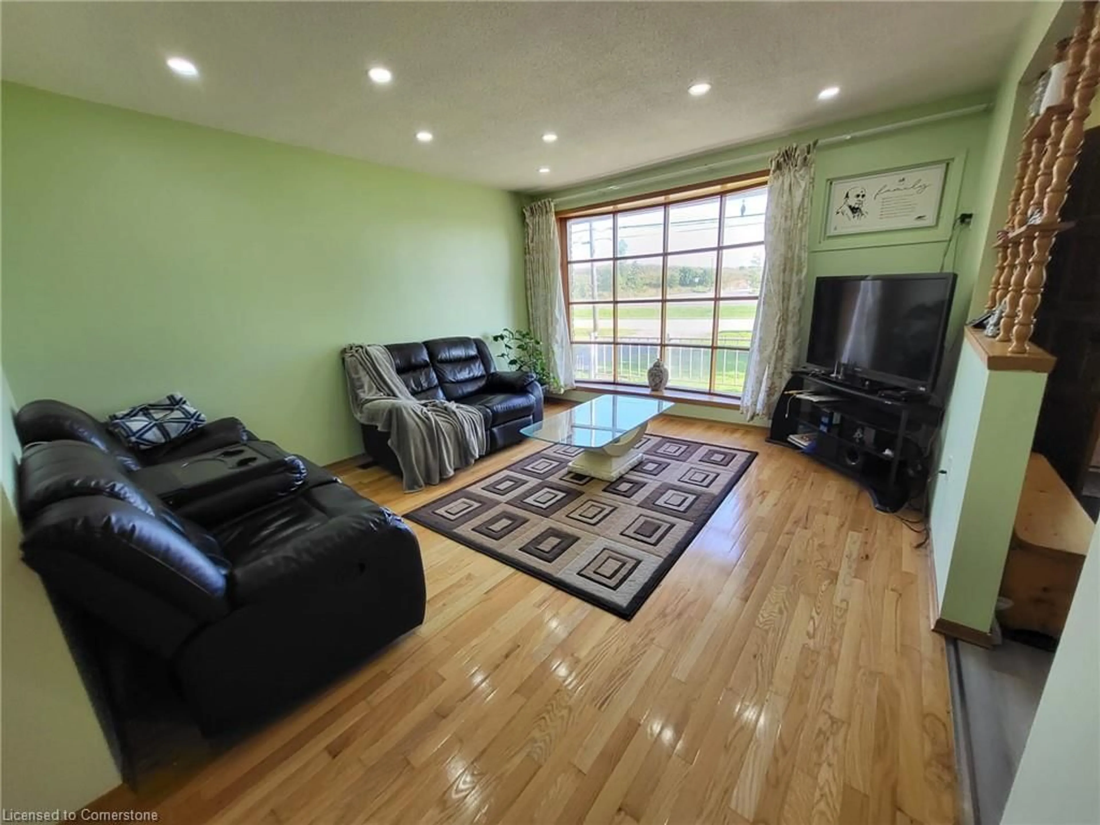 Living room with furniture, wood/laminate floor for 11 Penny Lane, Stoney Creek Ontario L8J 2V7