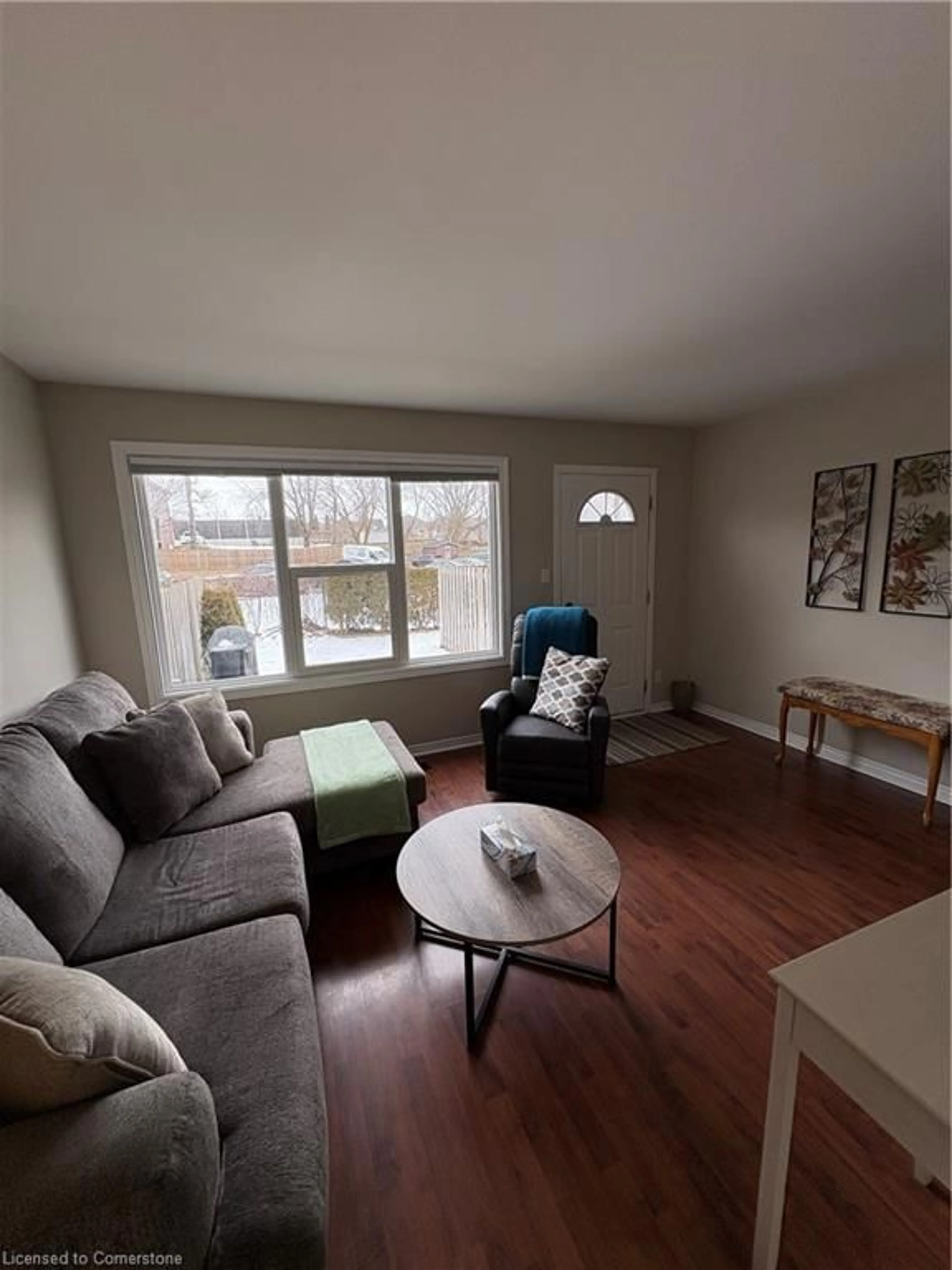 Living room with furniture, wood/laminate floor for 144 Concession St #21, Tillsonburg Ontario N4G 1N5