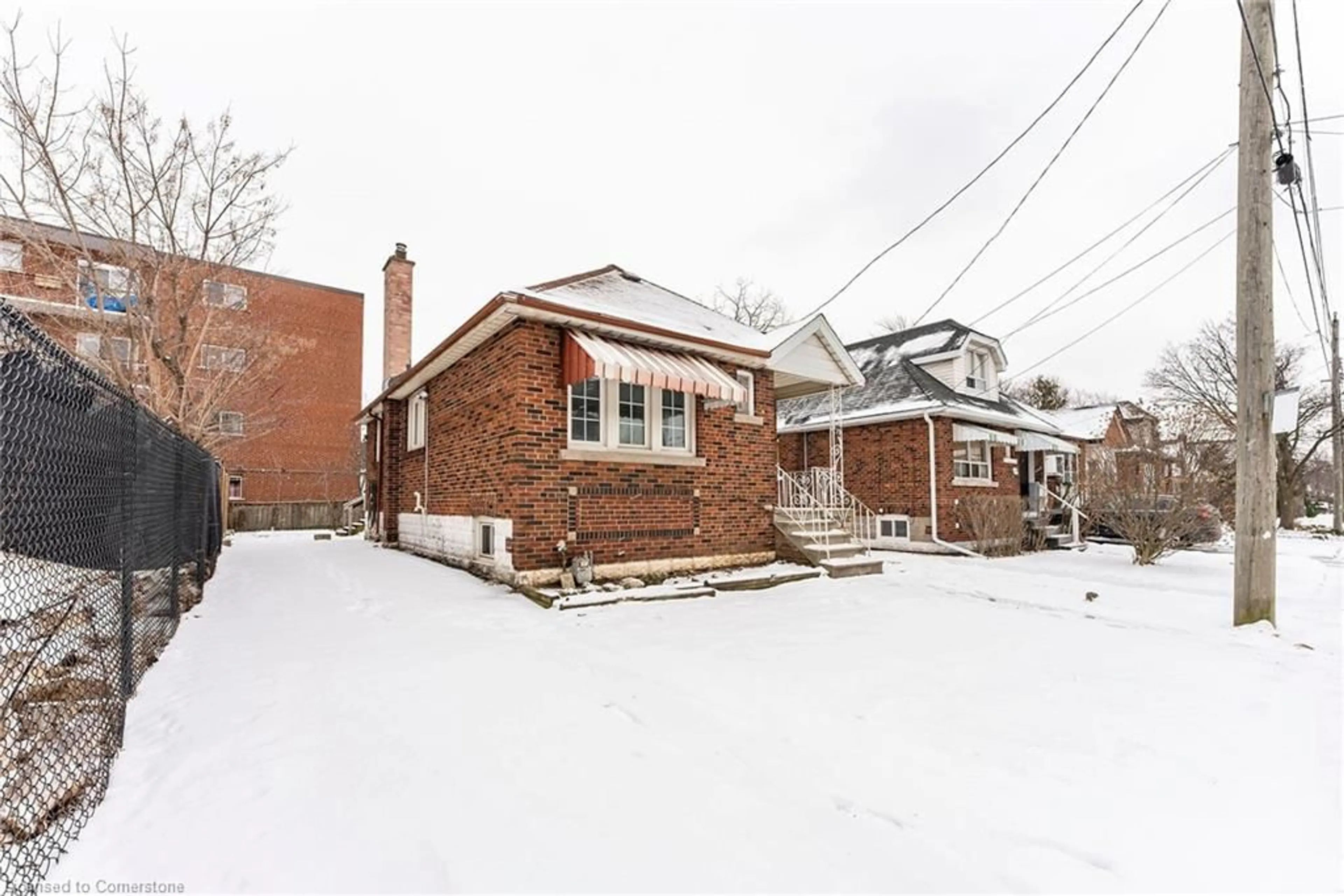 Home with brick exterior material, street for 15 East 12th St, Hamilton Ontario L9A 3X2