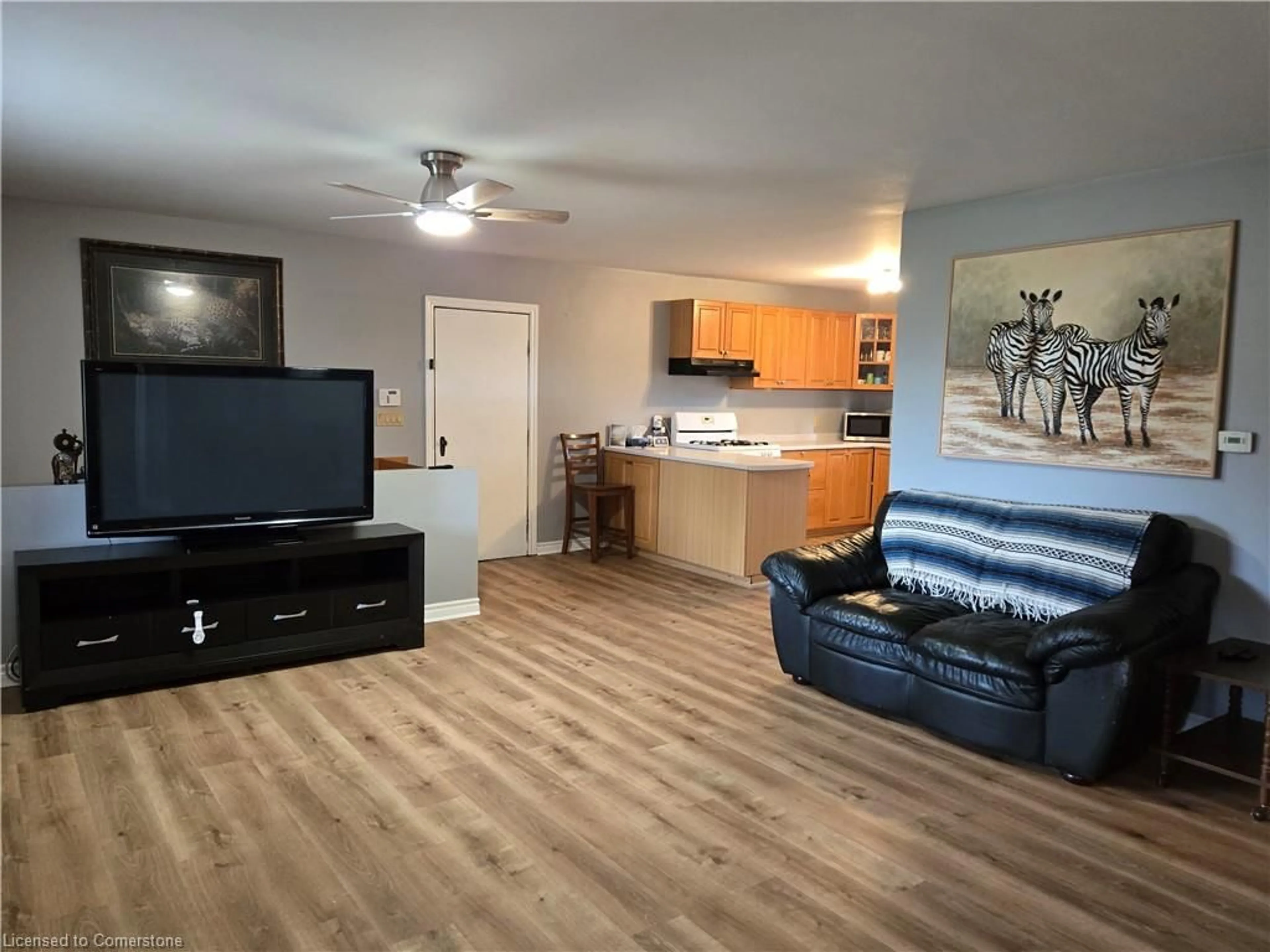 Living room with furniture, wood/laminate floor for 1060 Front Rd, Booth's Harbour Ontario N0E 1P0