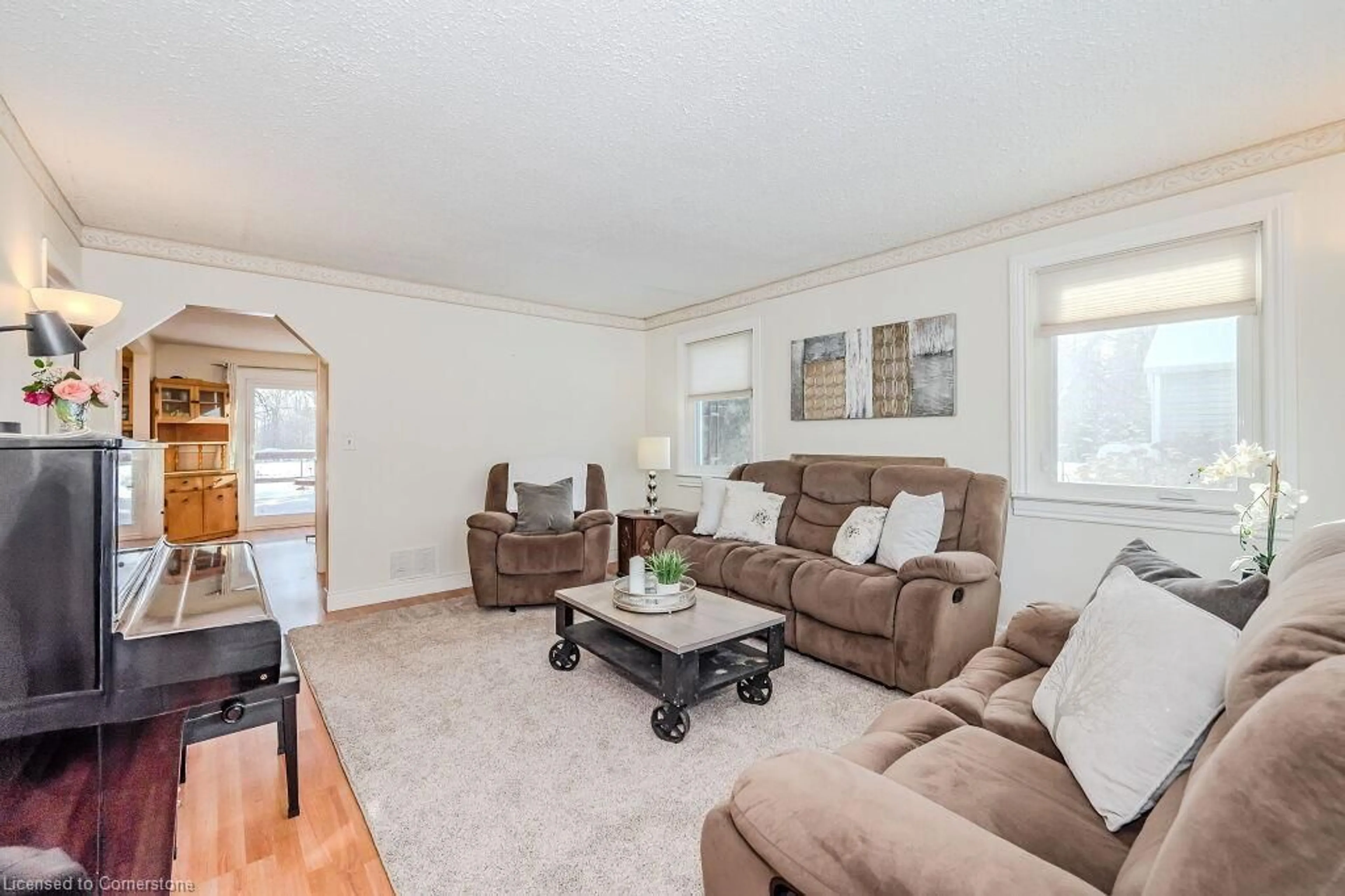 Living room with furniture, wood/laminate floor for 7210 Highway 7, Acton Ontario L7J 2L9