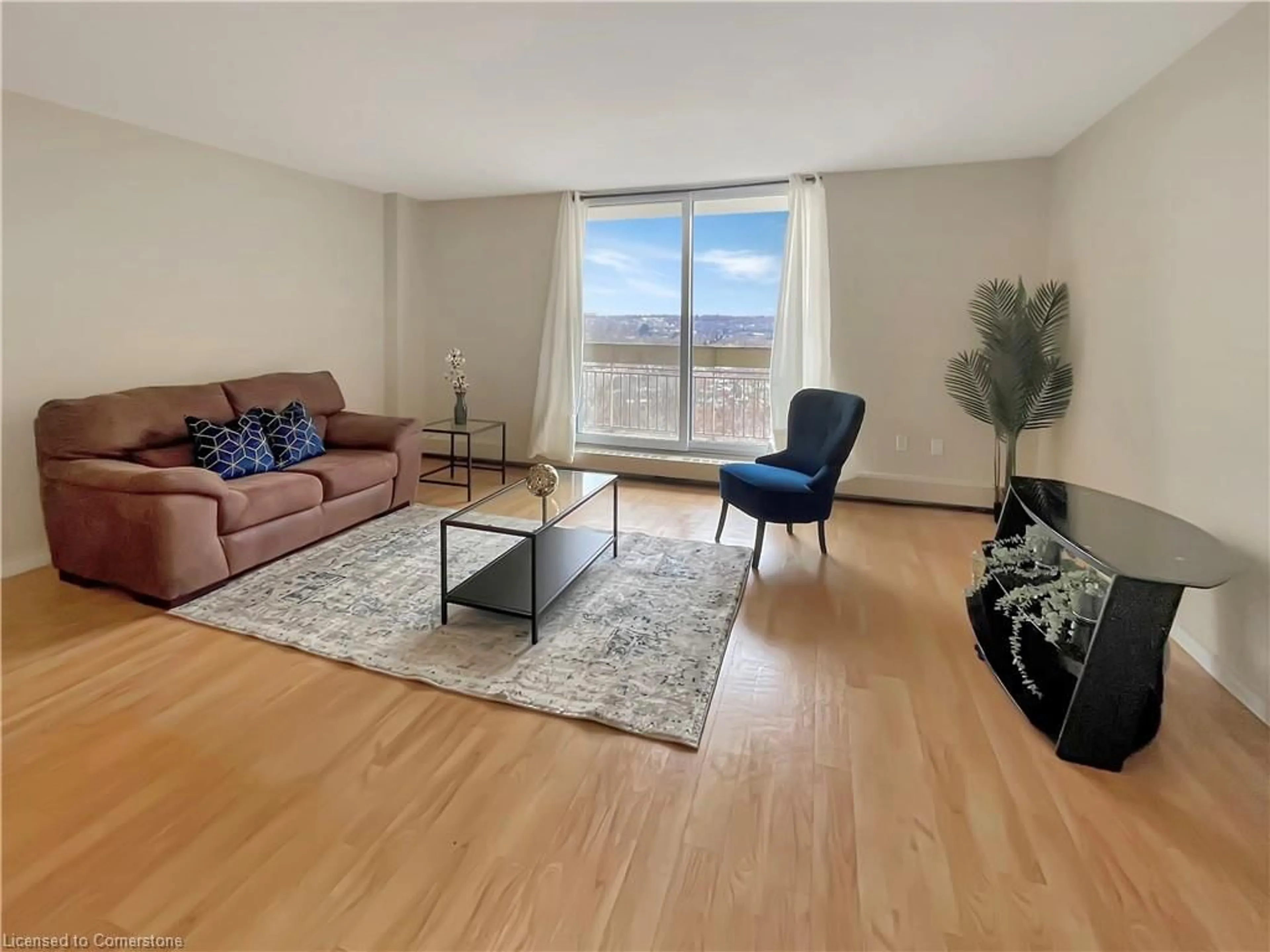 Living room with furniture, wood/laminate floor for 350 Quigley Rd #712, Hamilton Ontario L8K 5N2