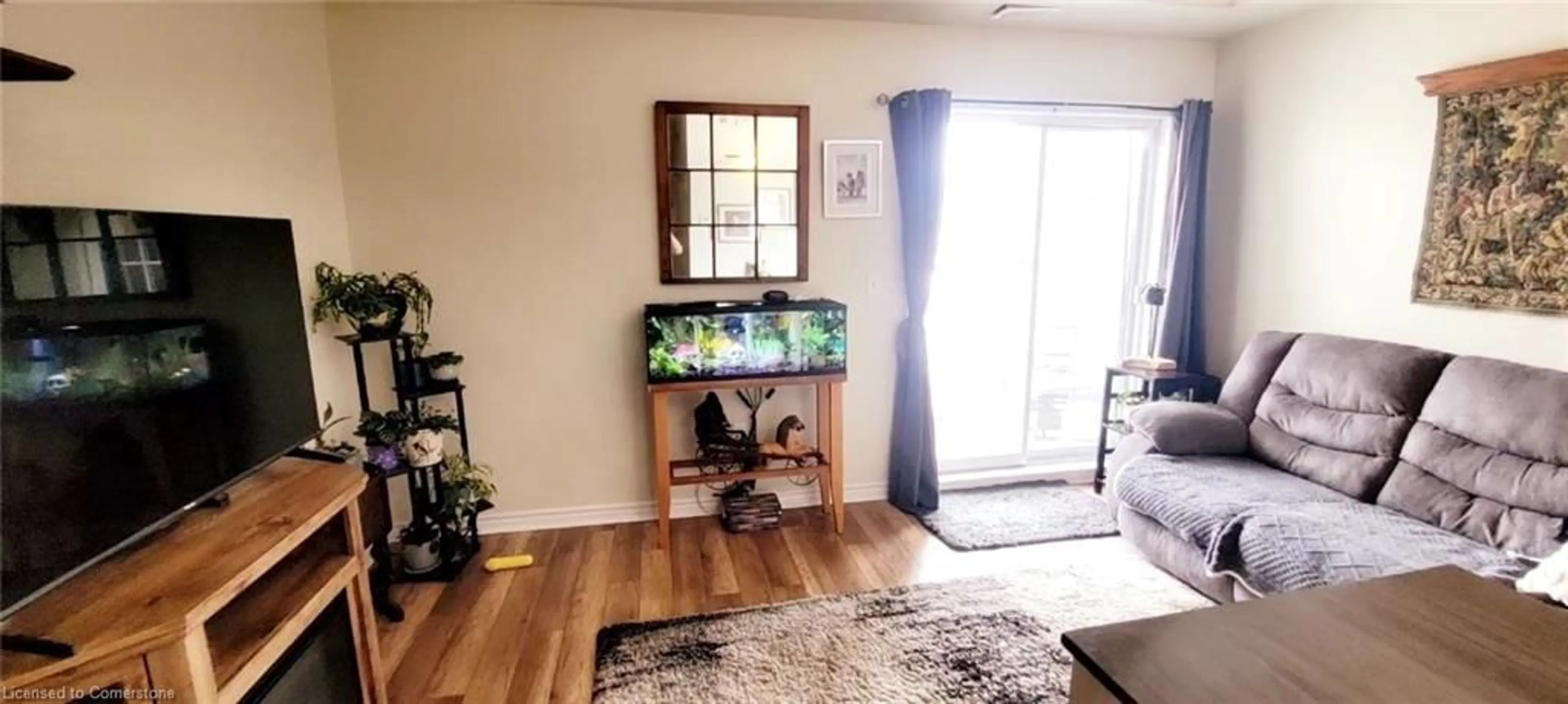 Living room with furniture, wood/laminate floor for 308 Watson Pky #118, Guelph Ontario N1E 0G7