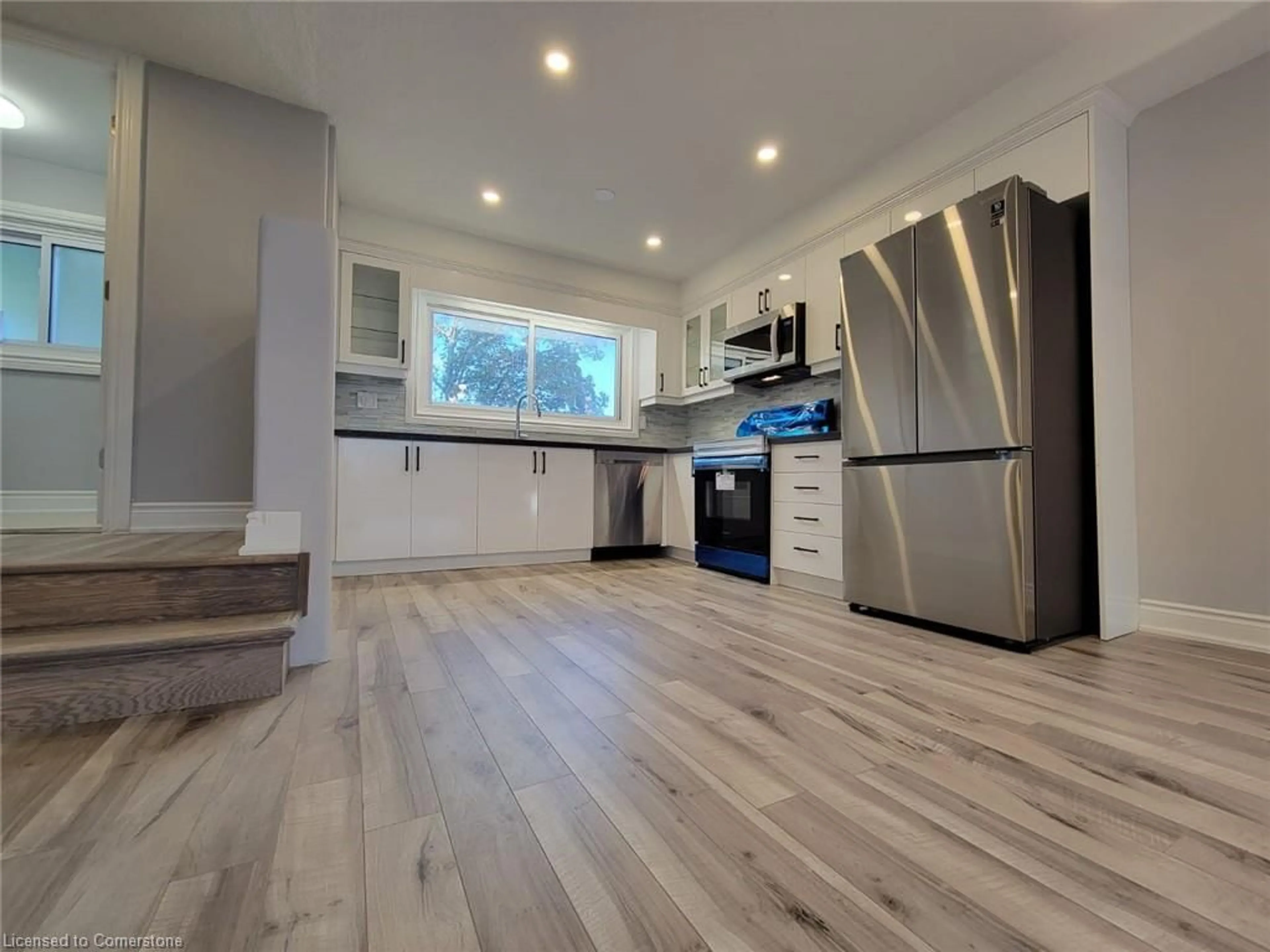 Open concept kitchen, wood/laminate floor for 125 Bonaventure Dr #8, Hamilton Ontario L9C 5Y9