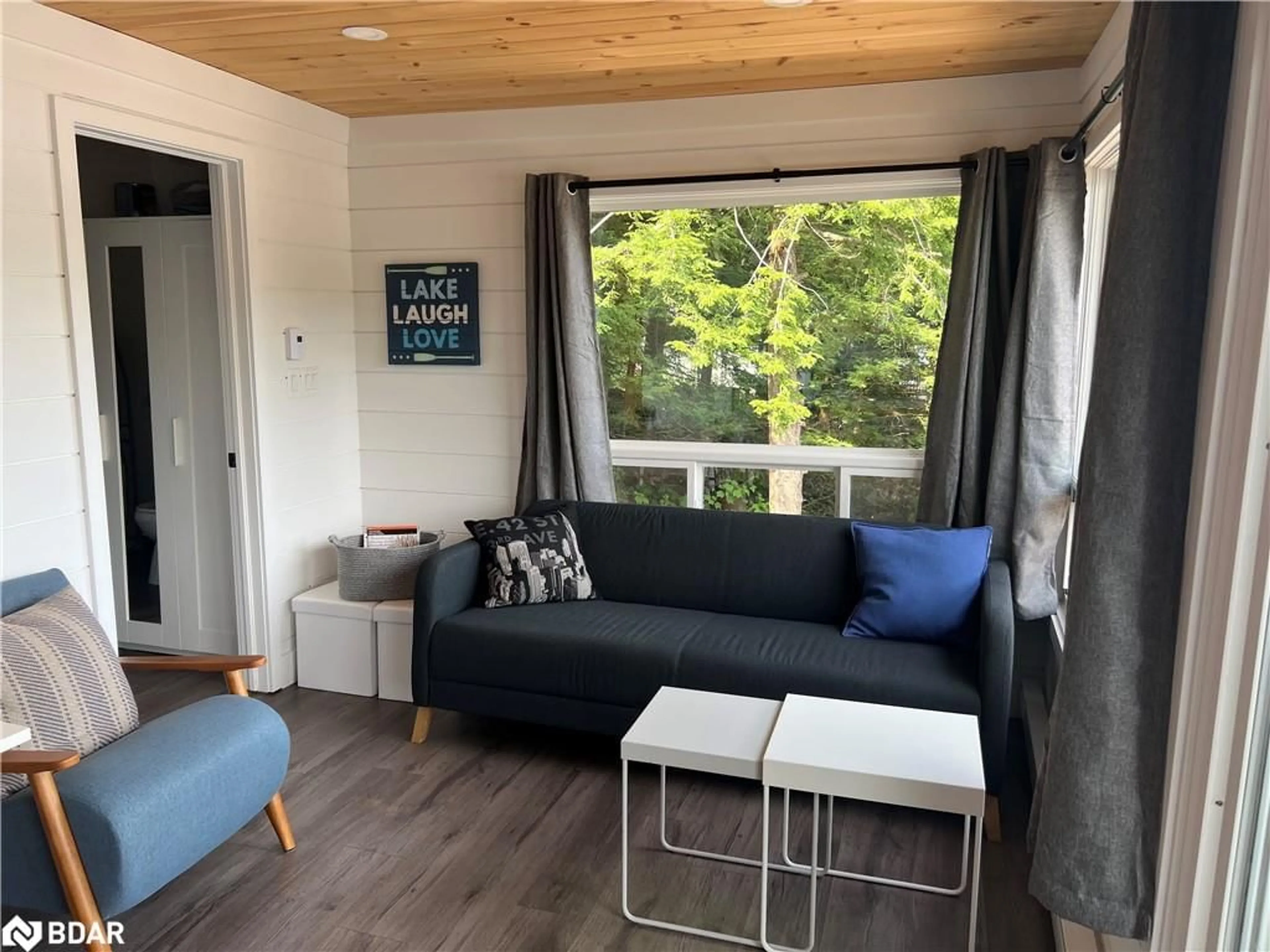 Living room with furniture, wood/laminate floor for 203 Healey Lake Water Rd, ARCHIPELAGO Ontario P0C 1H0