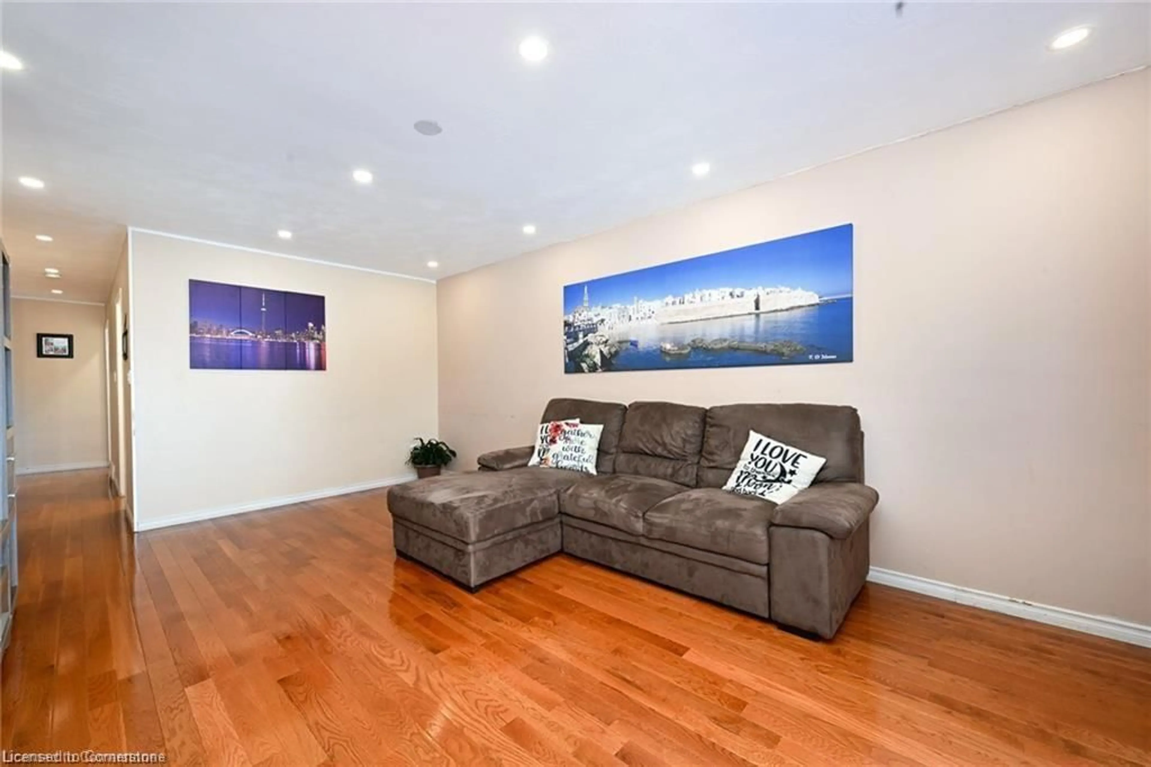 Living room with furniture, wood/laminate floor for 805 Stone Church Rd, Hamilton Ontario L8W 1A9