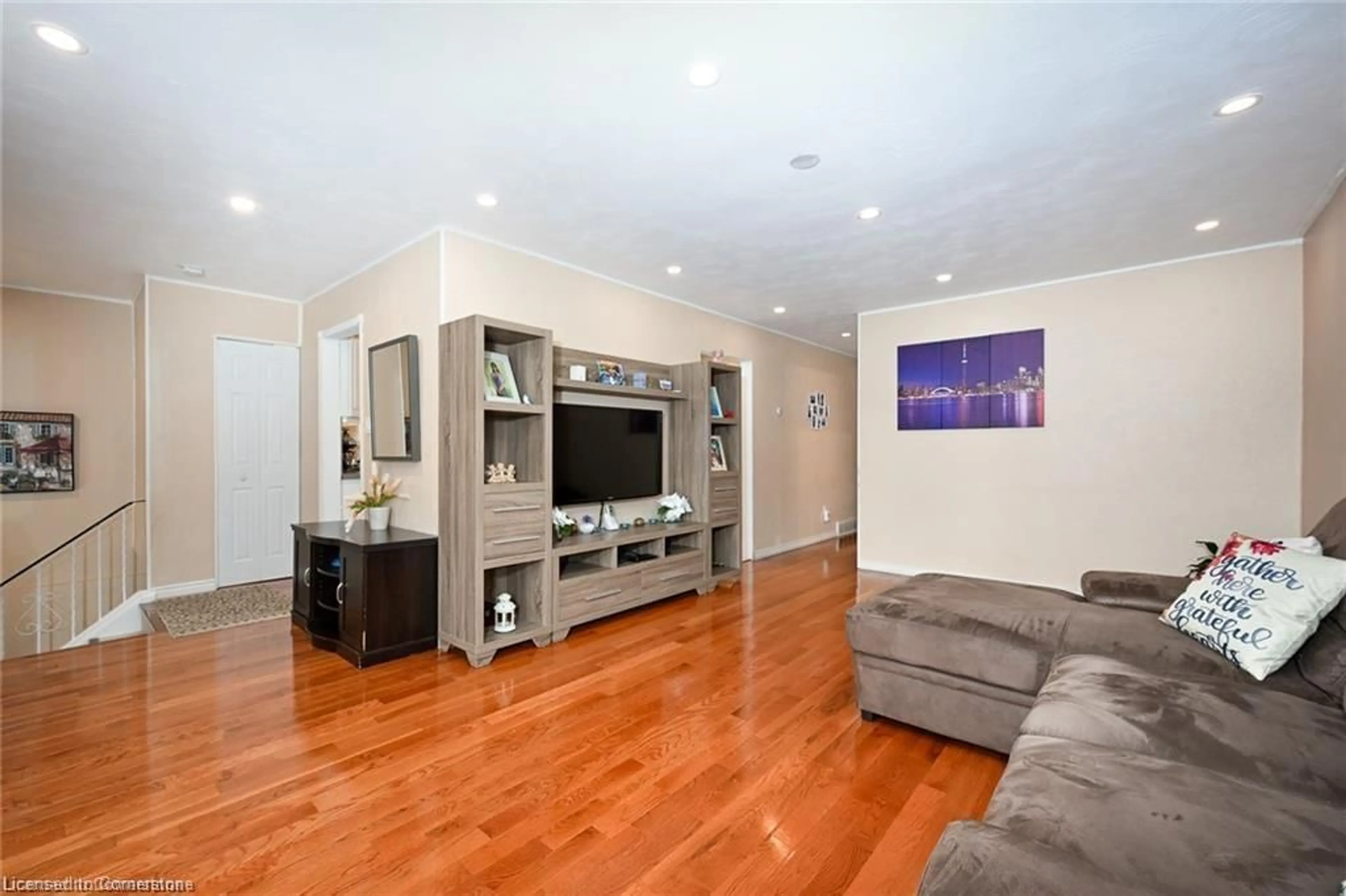 Living room with furniture, wood/laminate floor for 805 Stone Church Rd, Hamilton Ontario L8W 1A9