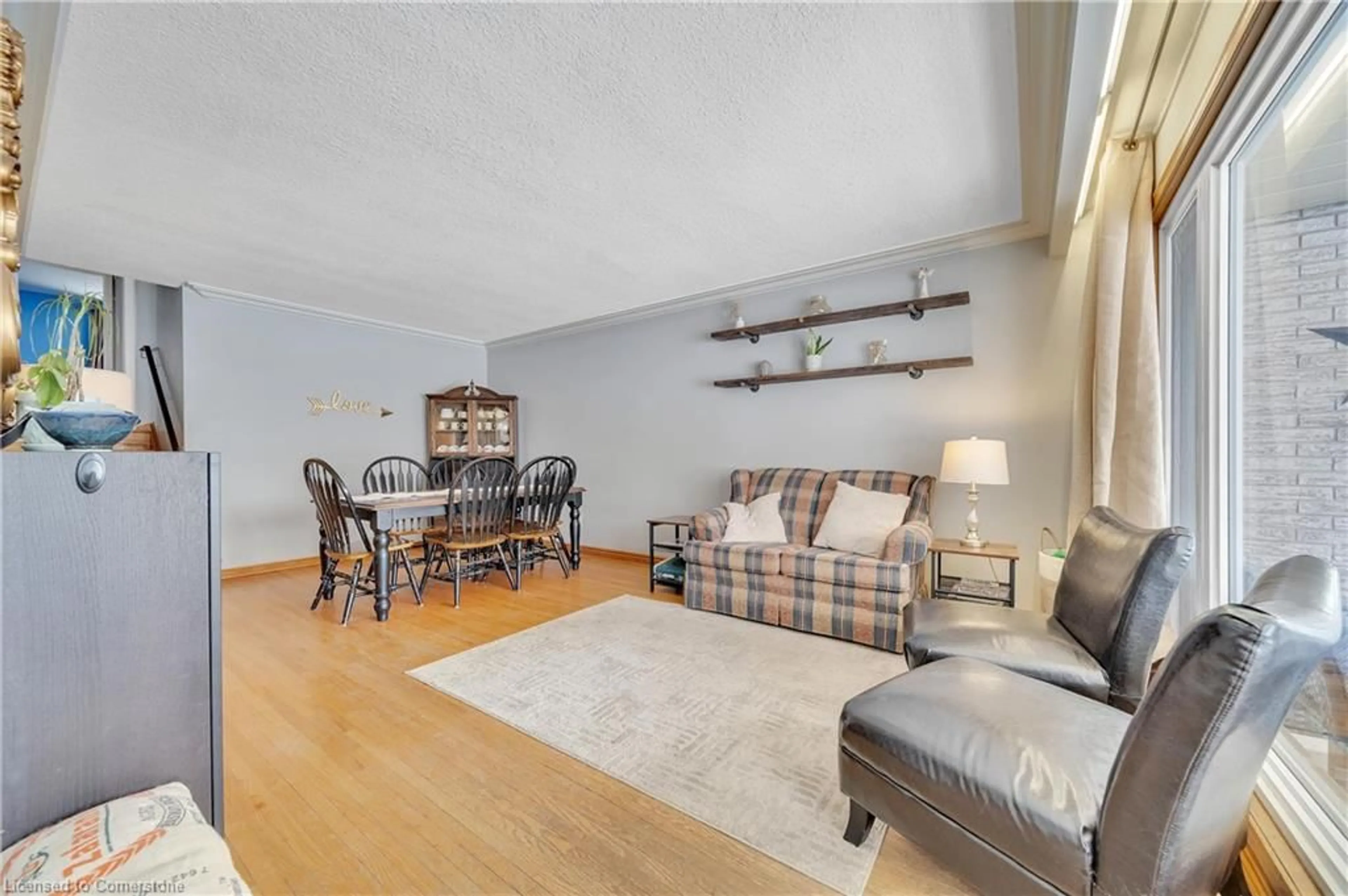 Living room with furniture, wood/laminate floor for 69 Rhonda Rd, Guelph Ontario N1H 6H3