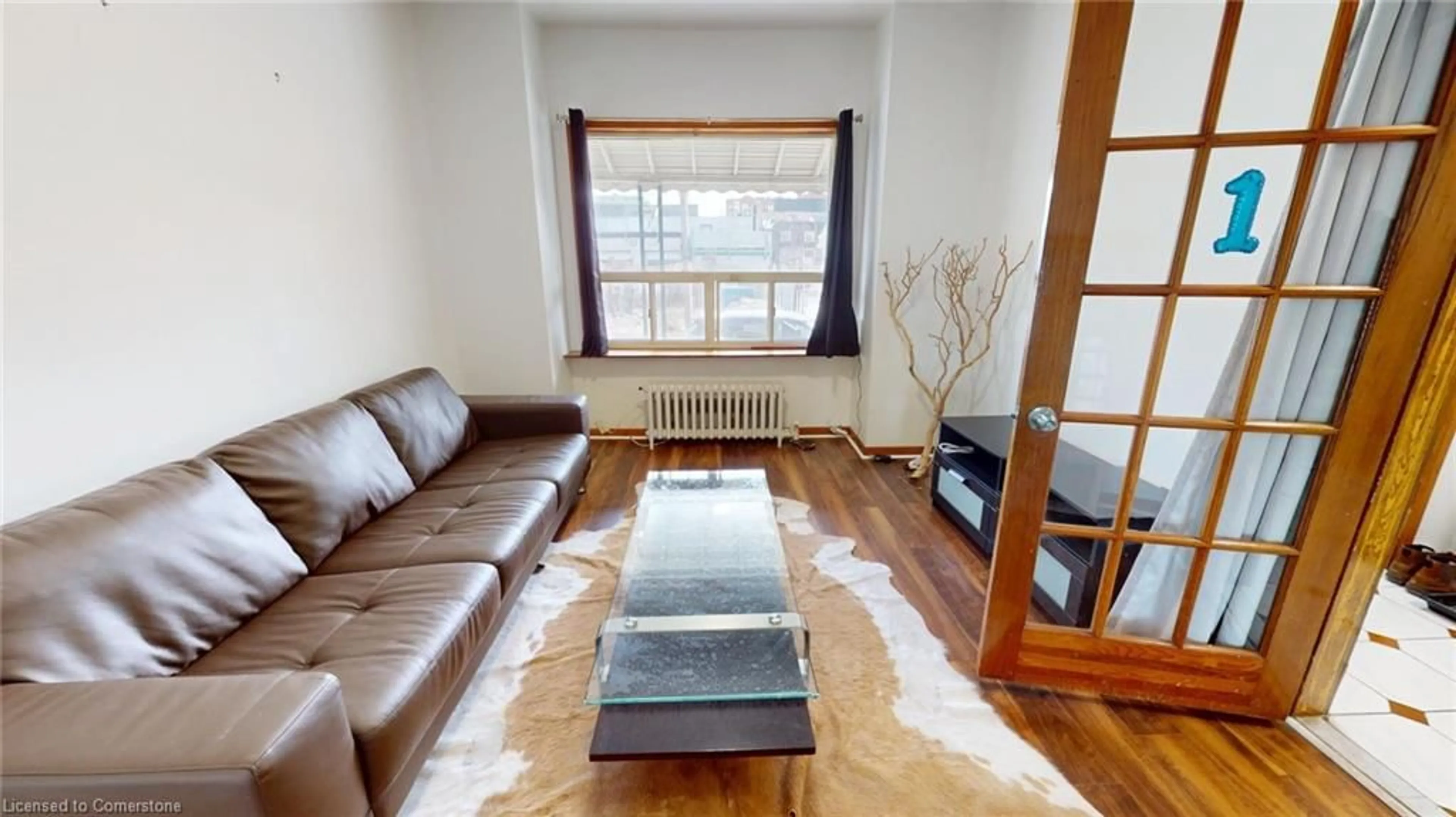 Living room with furniture, wood/laminate floor for 36 Mitchell Ave, Toronto Ontario M6J 1B9