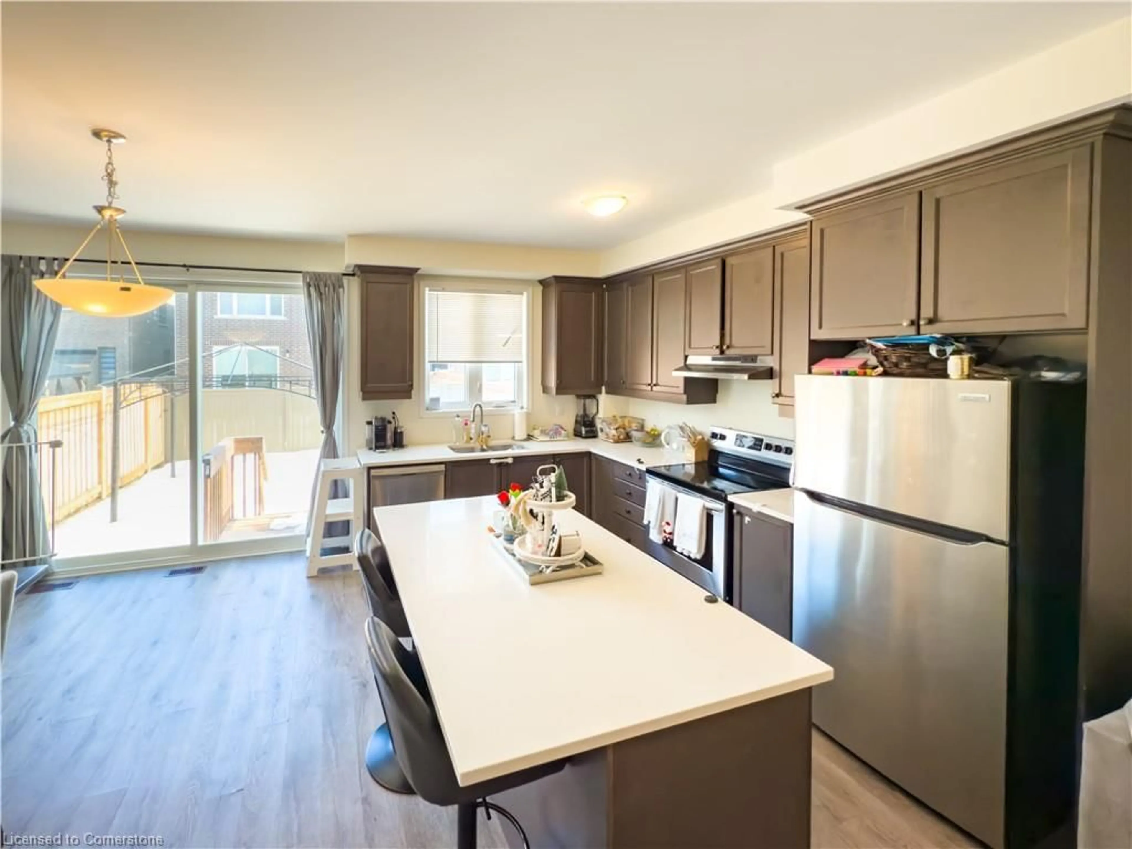 Open concept kitchen, wood/laminate floor for 888 Sumac Cres, Milton Ontario L9E 1R7