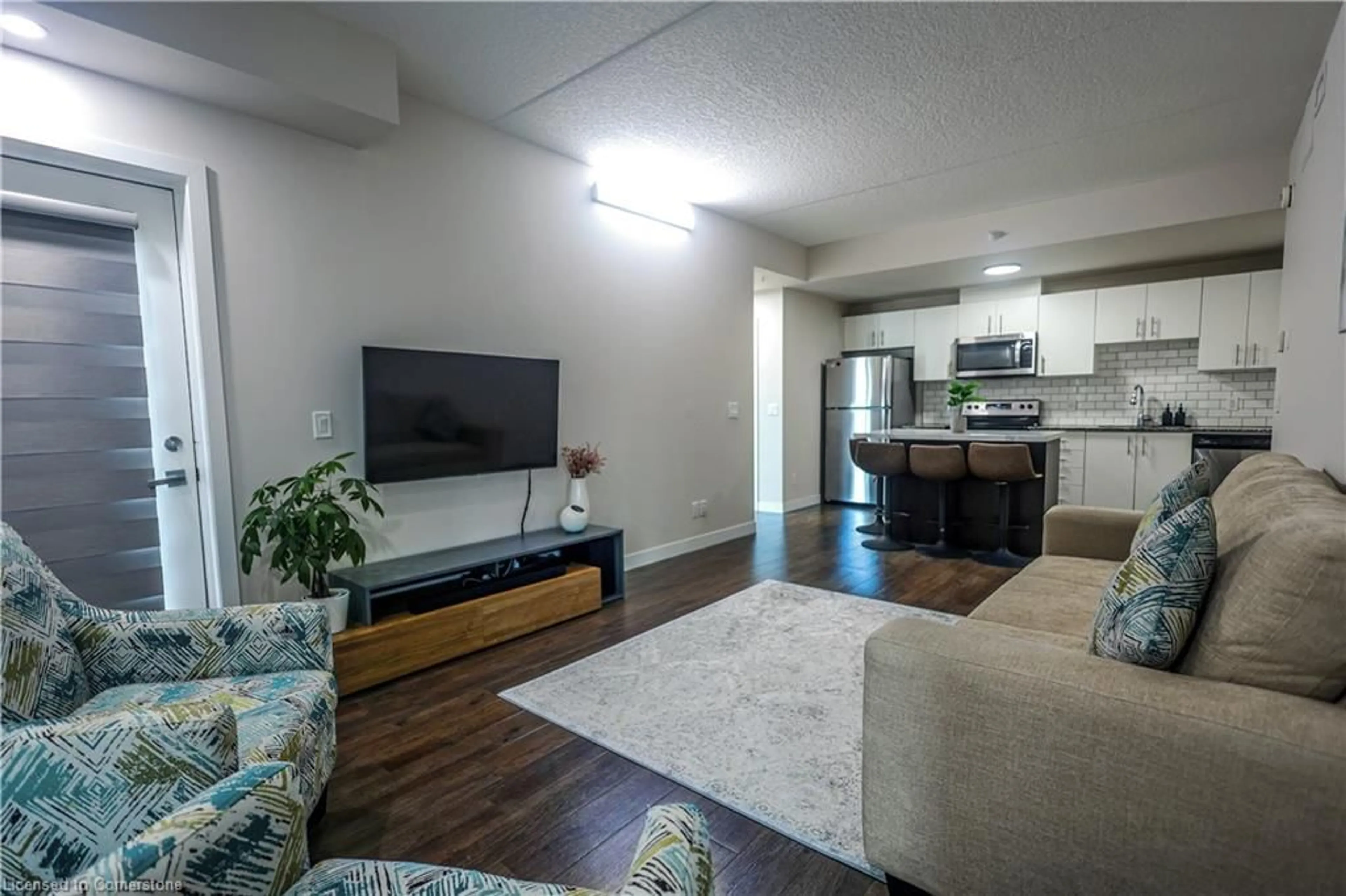 Living room with furniture, wood/laminate floor for 175 Commonwealth St #205, Kitchener Ontario N2E 0H4