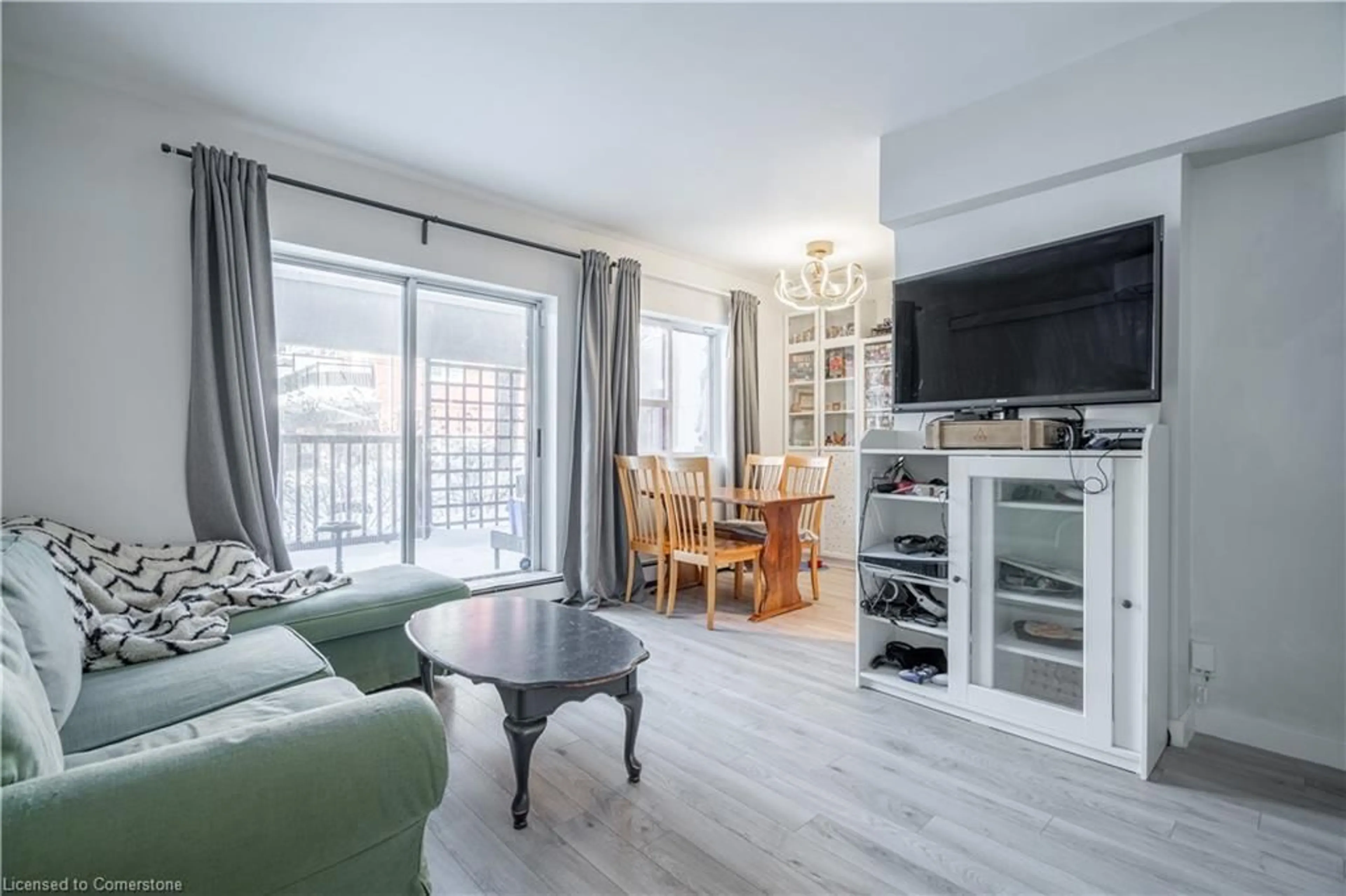 Living room with furniture, wood/laminate floor for 141 Catharine St #103, Hamilton Ontario L8N 2J7