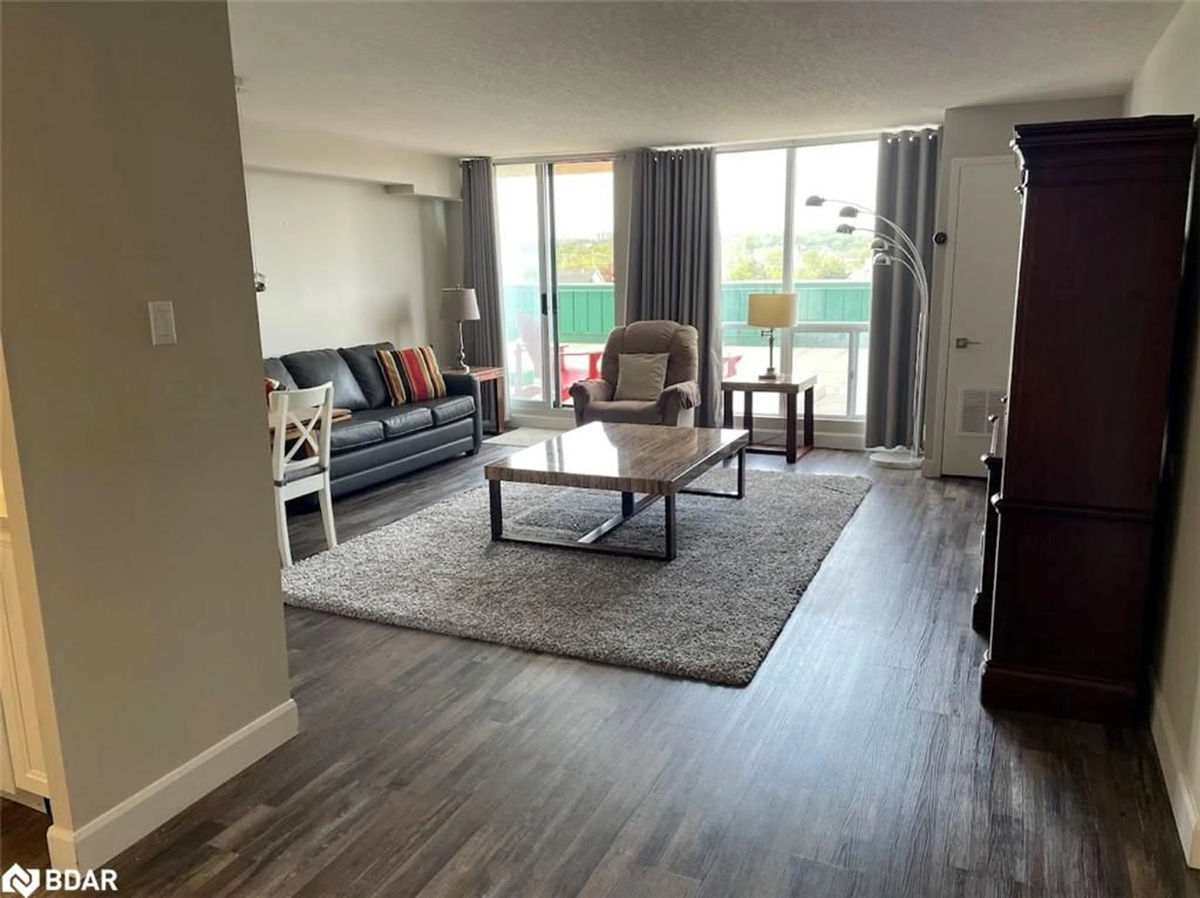 Living room with furniture, wood/laminate floor for 65 Ellen St #111, Barrie Ontario L4N 3A5