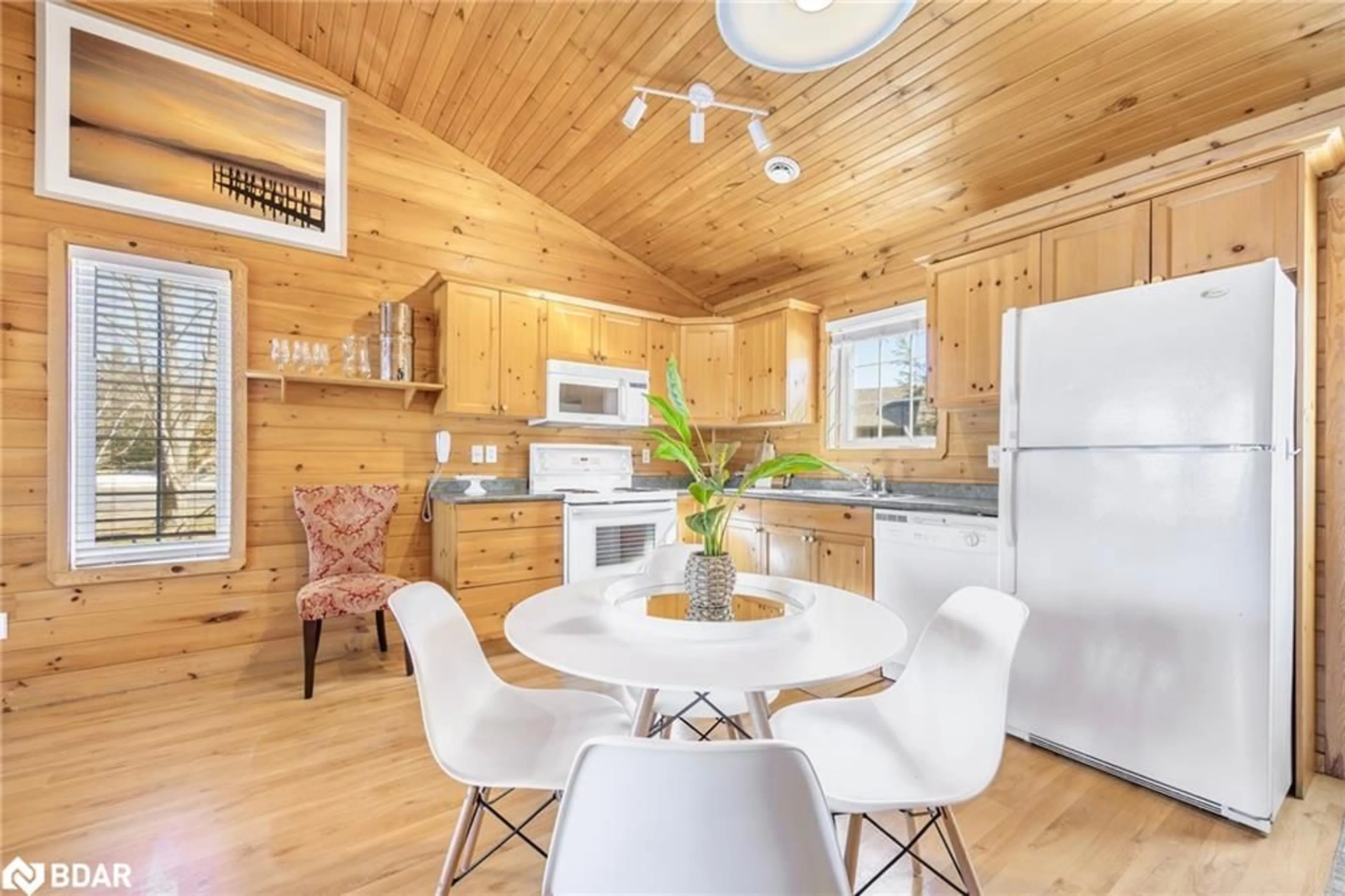 Open concept kitchen, wood/laminate floor for 26 Cabin Cres, Wasaga Beach Ontario L9Z 1X7
