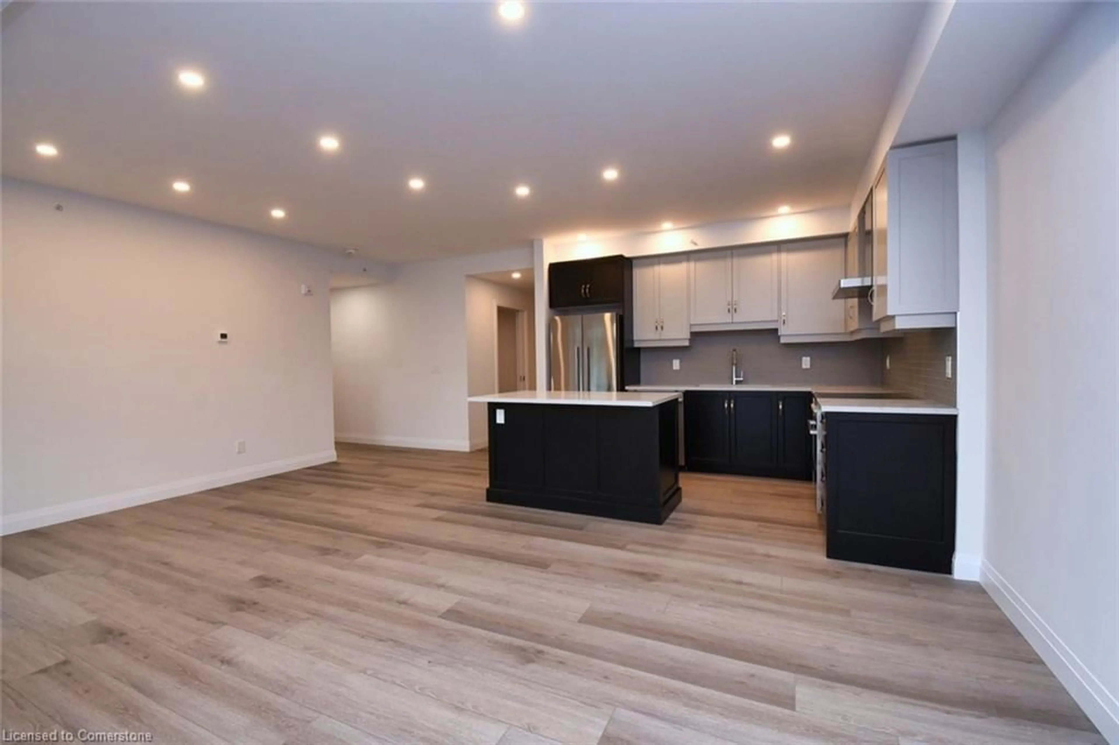 Open concept kitchen, wood/laminate floor for 153 Wilson St #306, Ancaster Ontario L9G 1N4