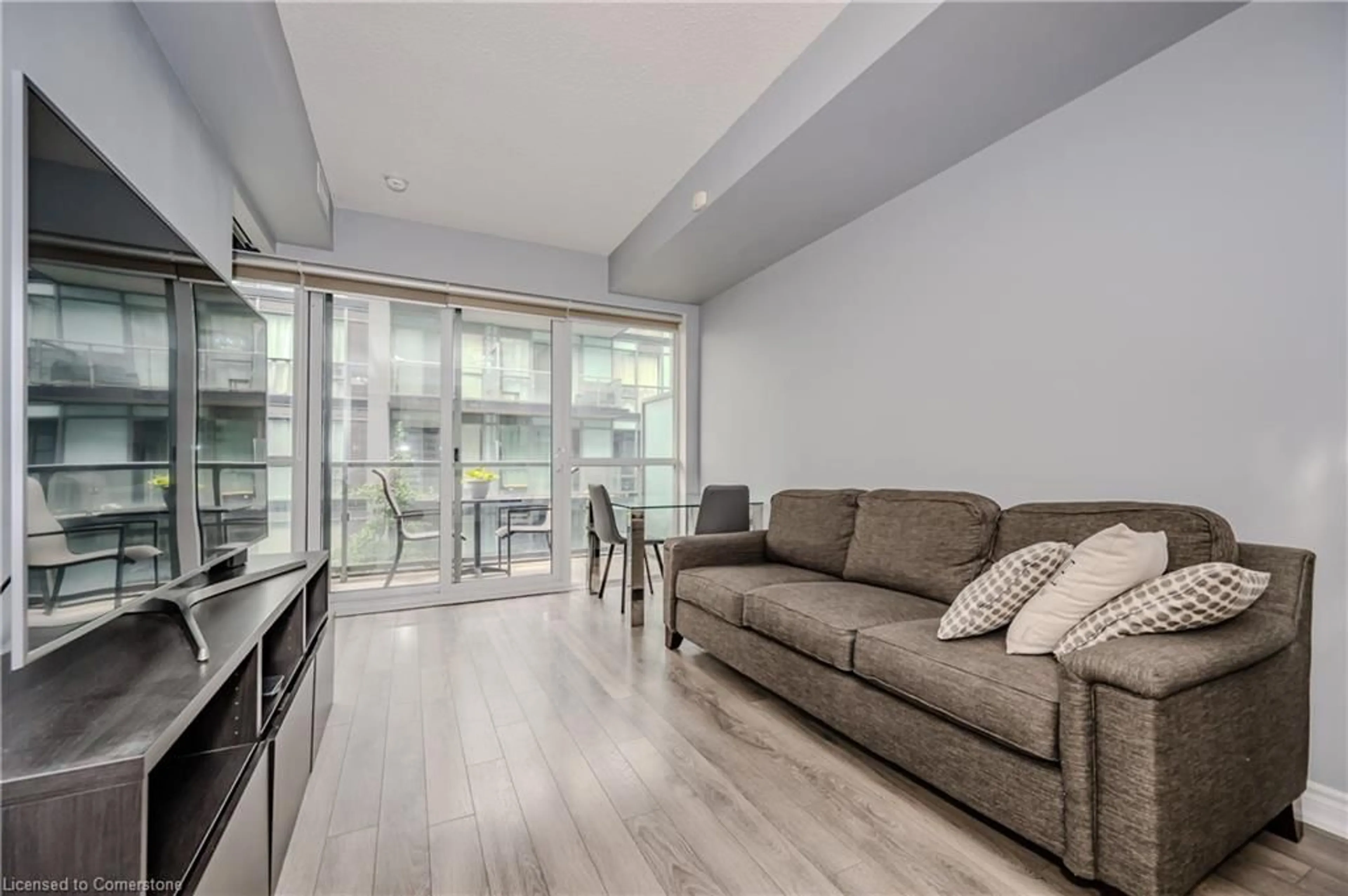 Living room with furniture, wood/laminate floor for 15 James Finlay Way #917, Toronto Ontario M3M 0B3