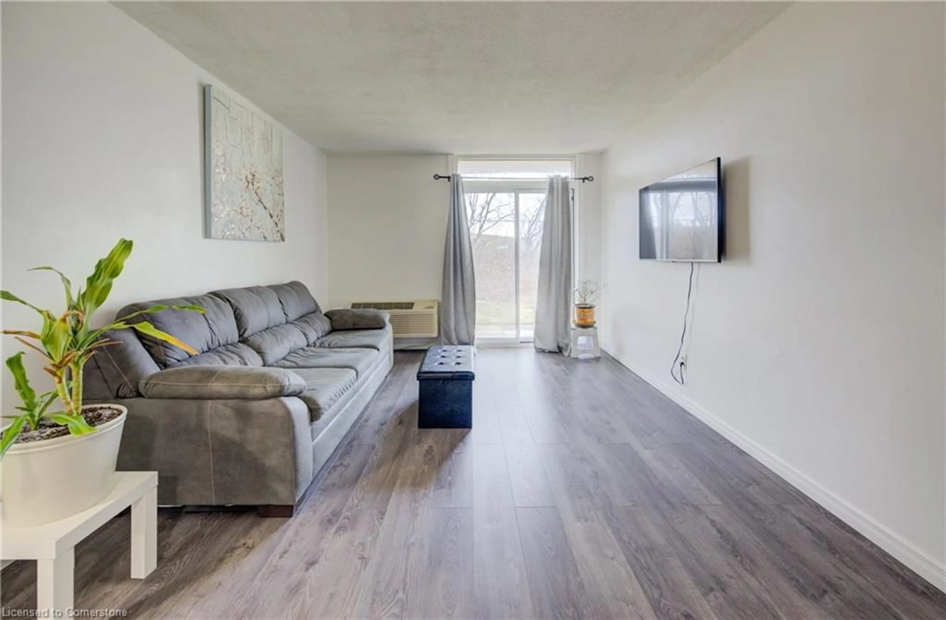 Living room with furniture, wood/laminate floor for 185 Kehl St #103, Kitchener Ontario N2M 5B9