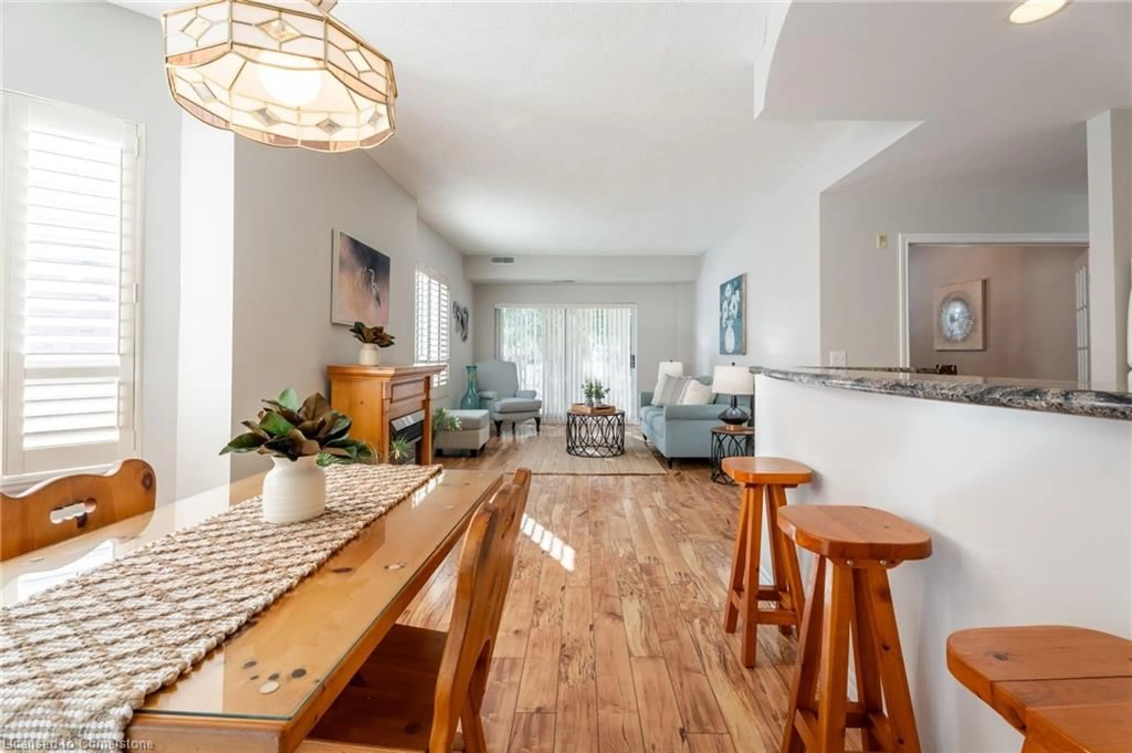Living room with furniture, wood/laminate floor for 5188 Lakeshore Rd #102, Burlington Ontario L7L 6P4