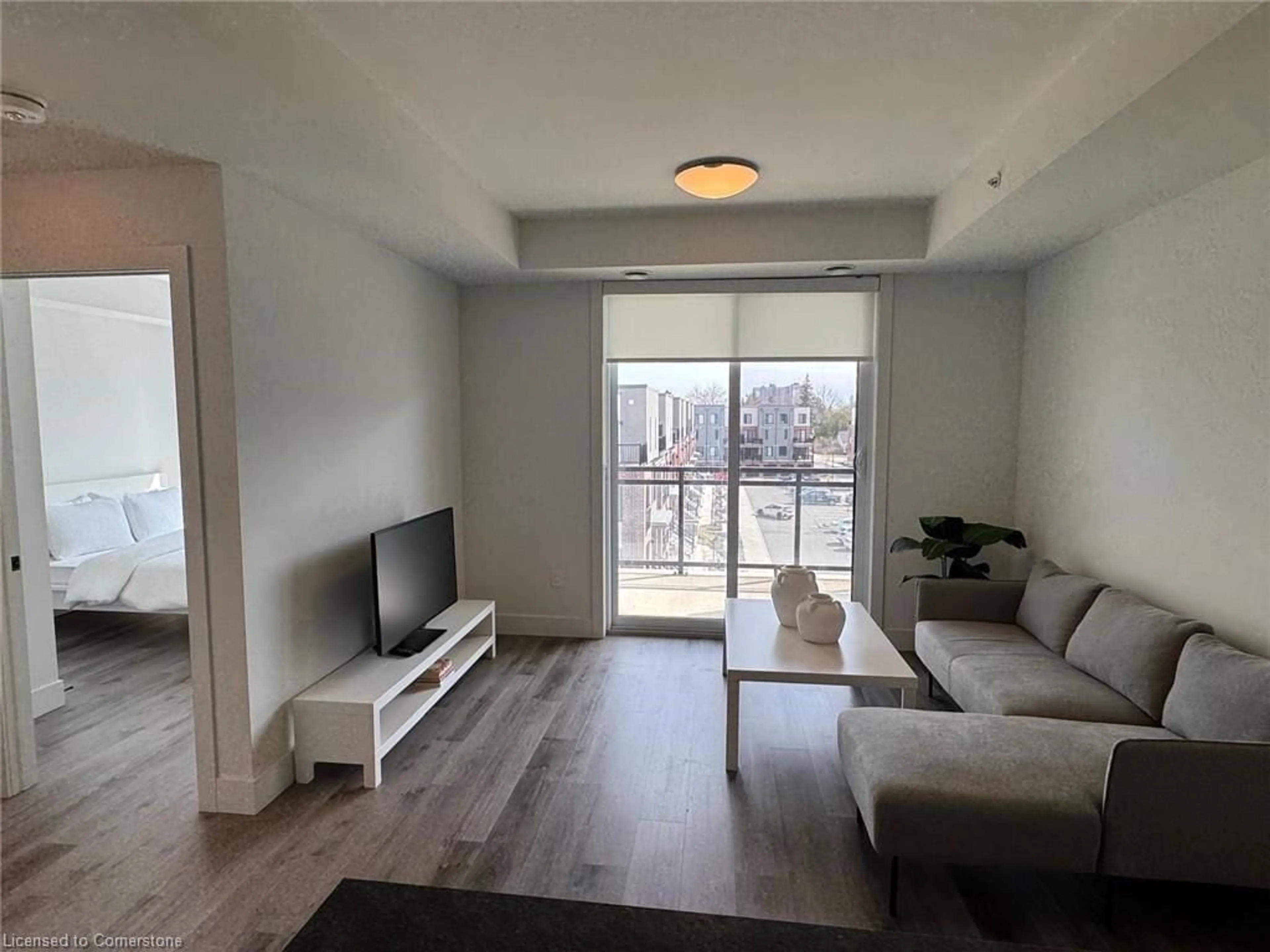 Living room with furniture, wood/laminate floor for 103 Roger St #403, Waterloo Ontario N2J 0G2