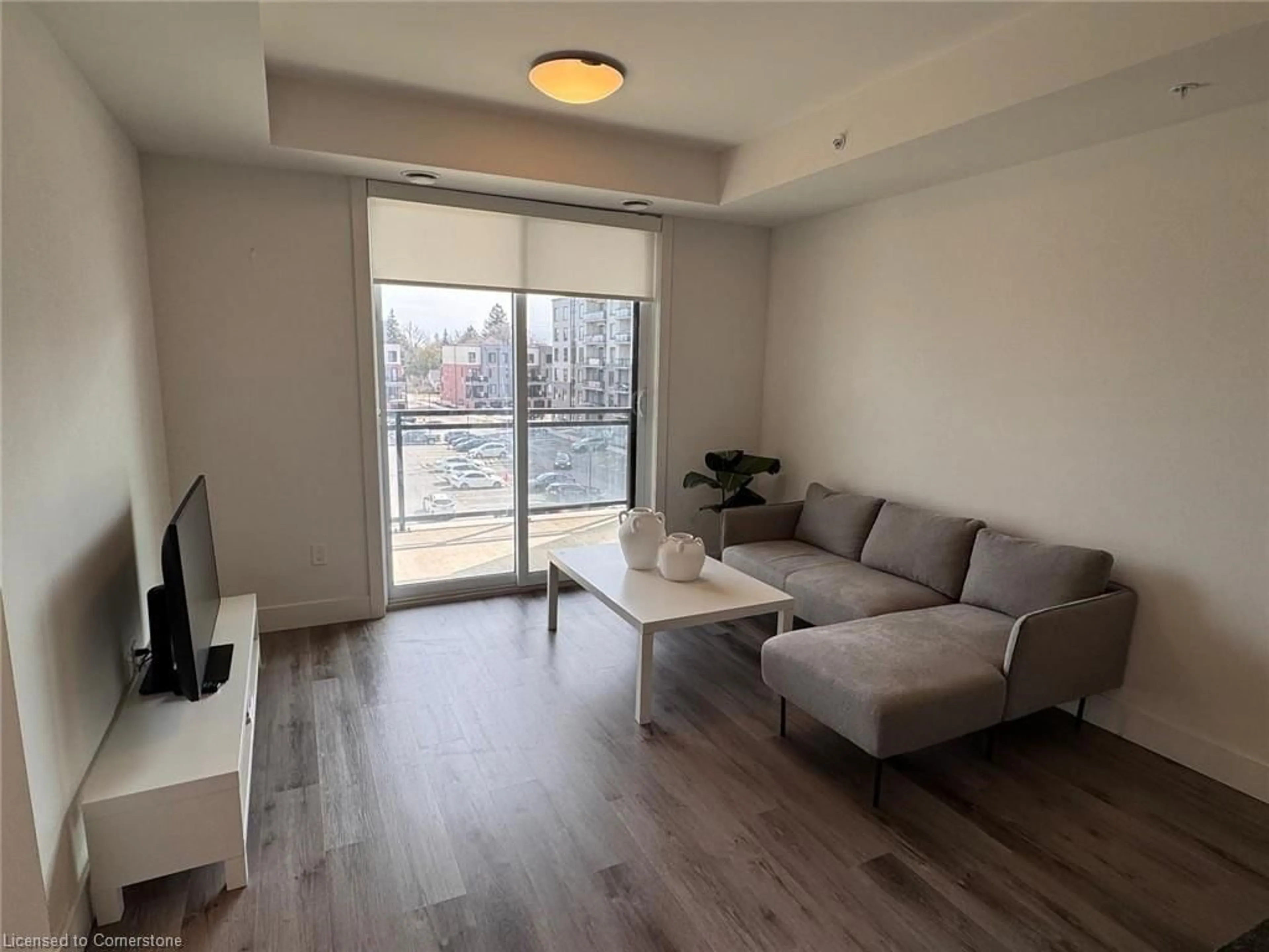 Living room with furniture, wood/laminate floor for 103 Roger St #403, Waterloo Ontario N2J 0G2