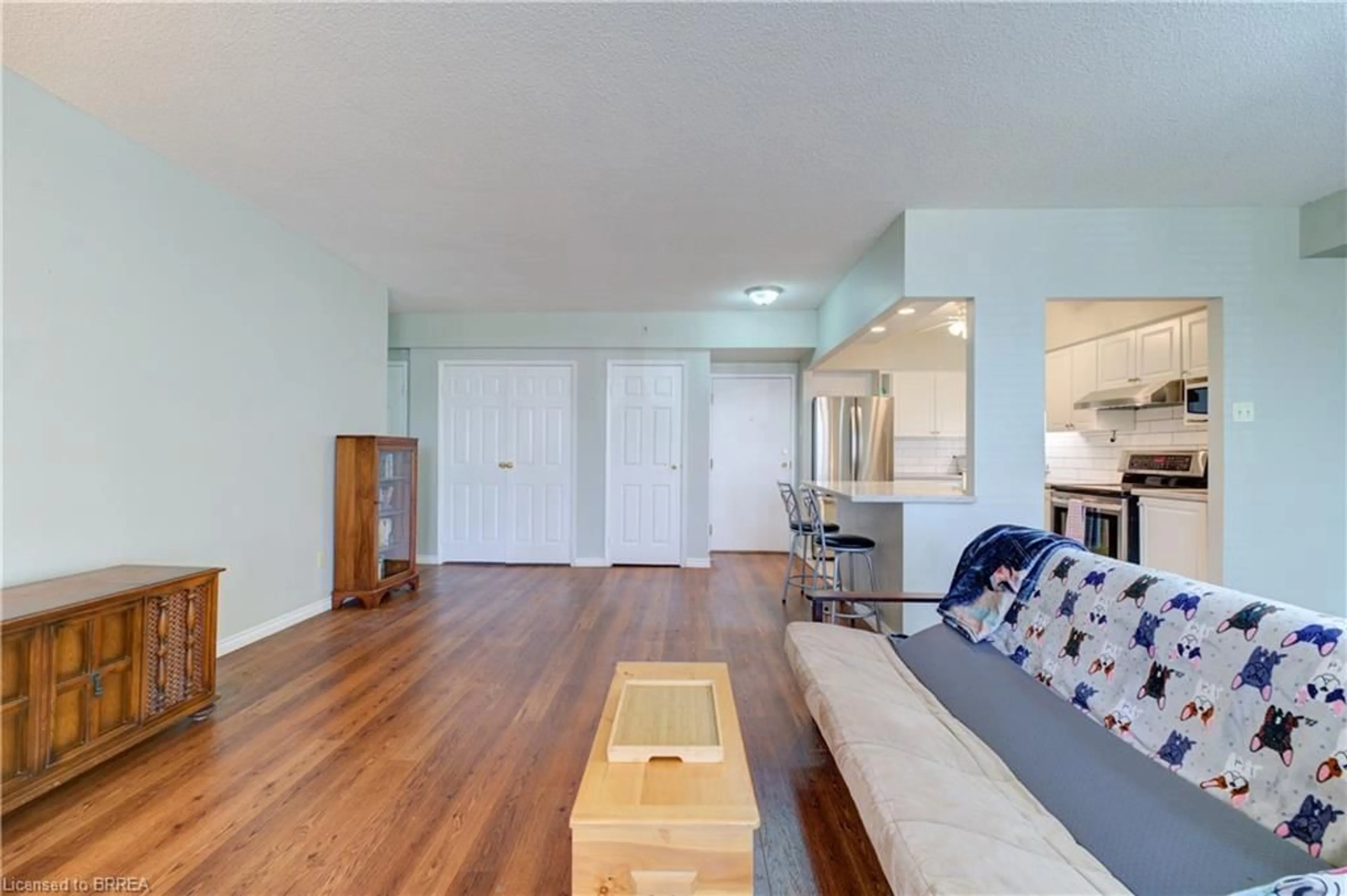 Living room with furniture, wood/laminate floor for 9 Bonheur Crt #109, Brantford Ontario N3P 1Z5