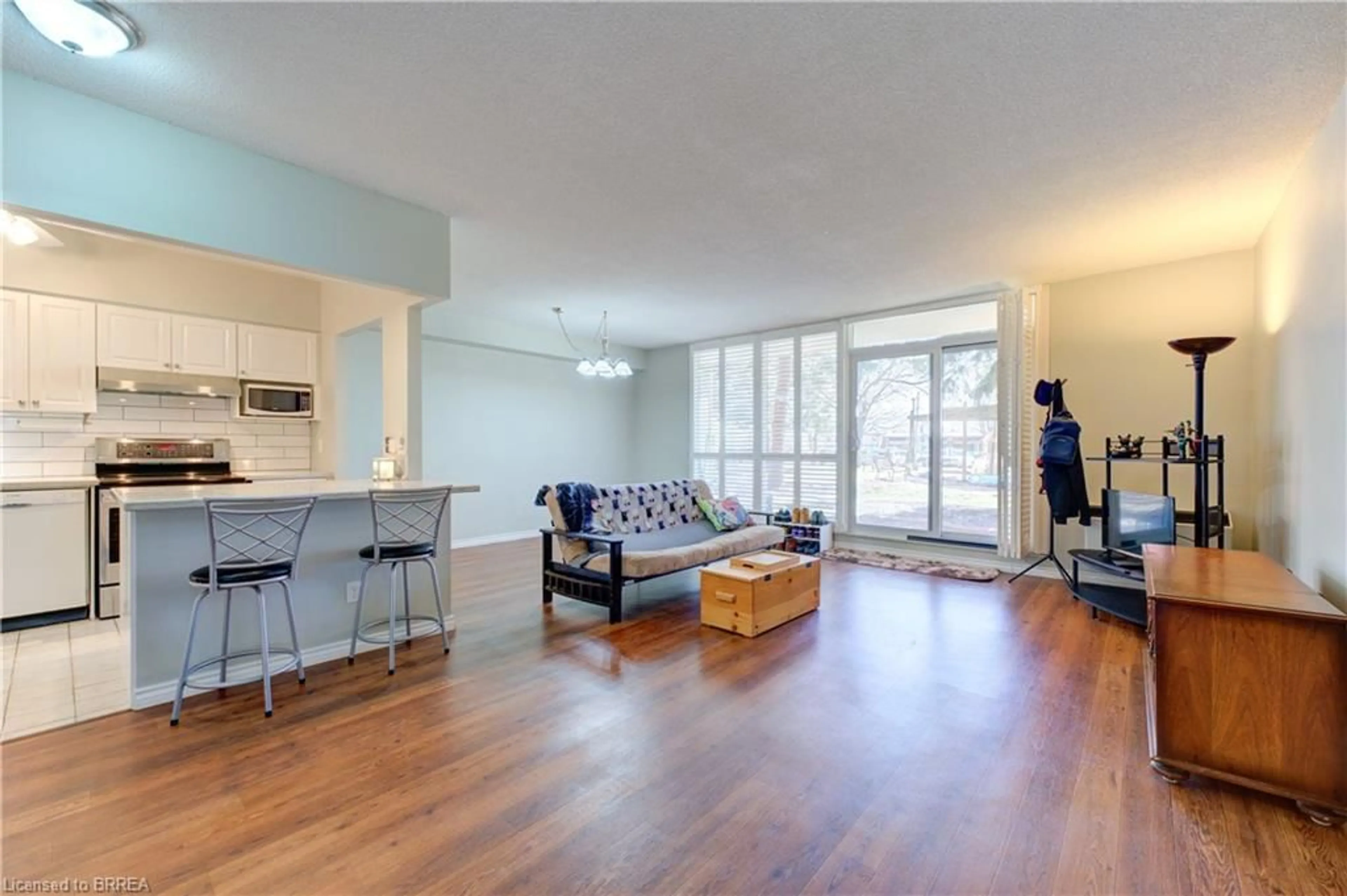 Living room with furniture, wood/laminate floor for 9 Bonheur Crt #109, Brantford Ontario N3P 1Z5