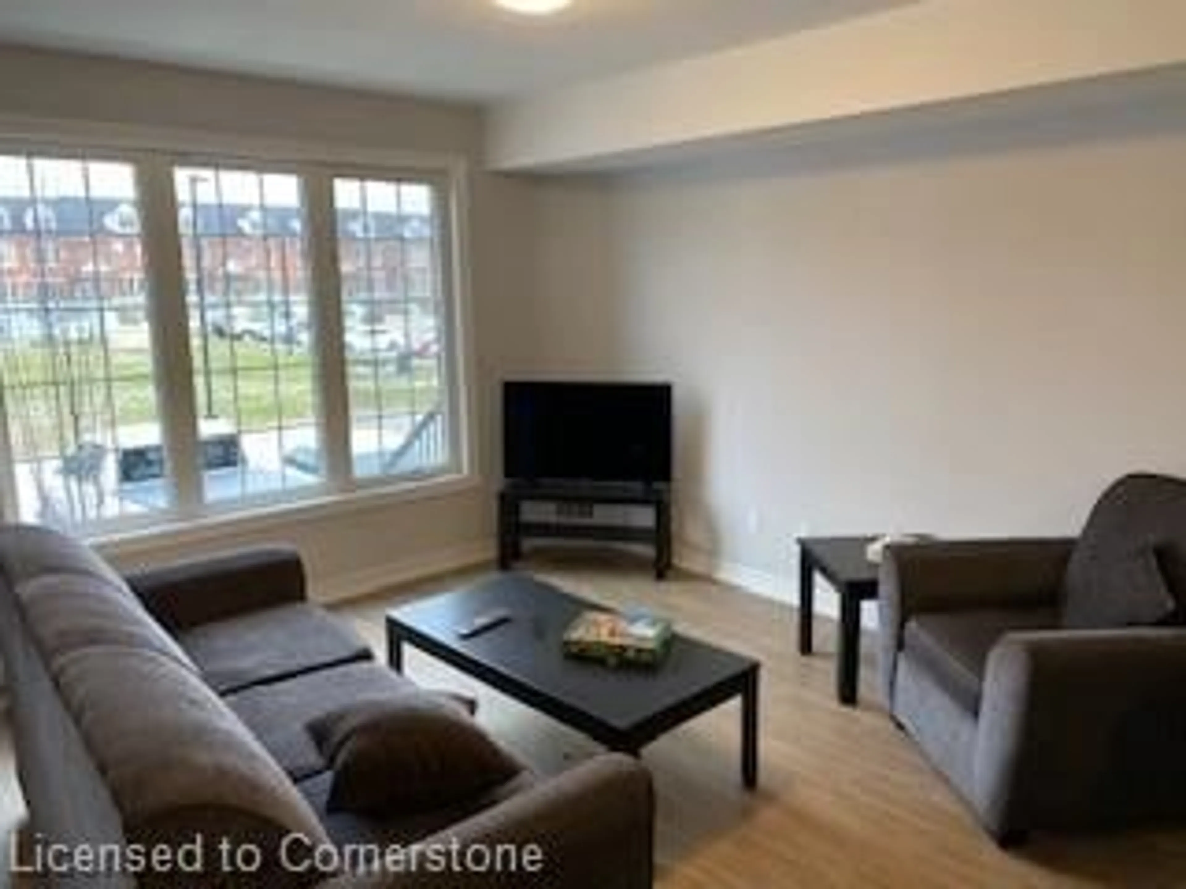 Living room with furniture, wood/laminate floor for 242 Penetanguishene Rd #15, Barrie Ontario L4M 7C2