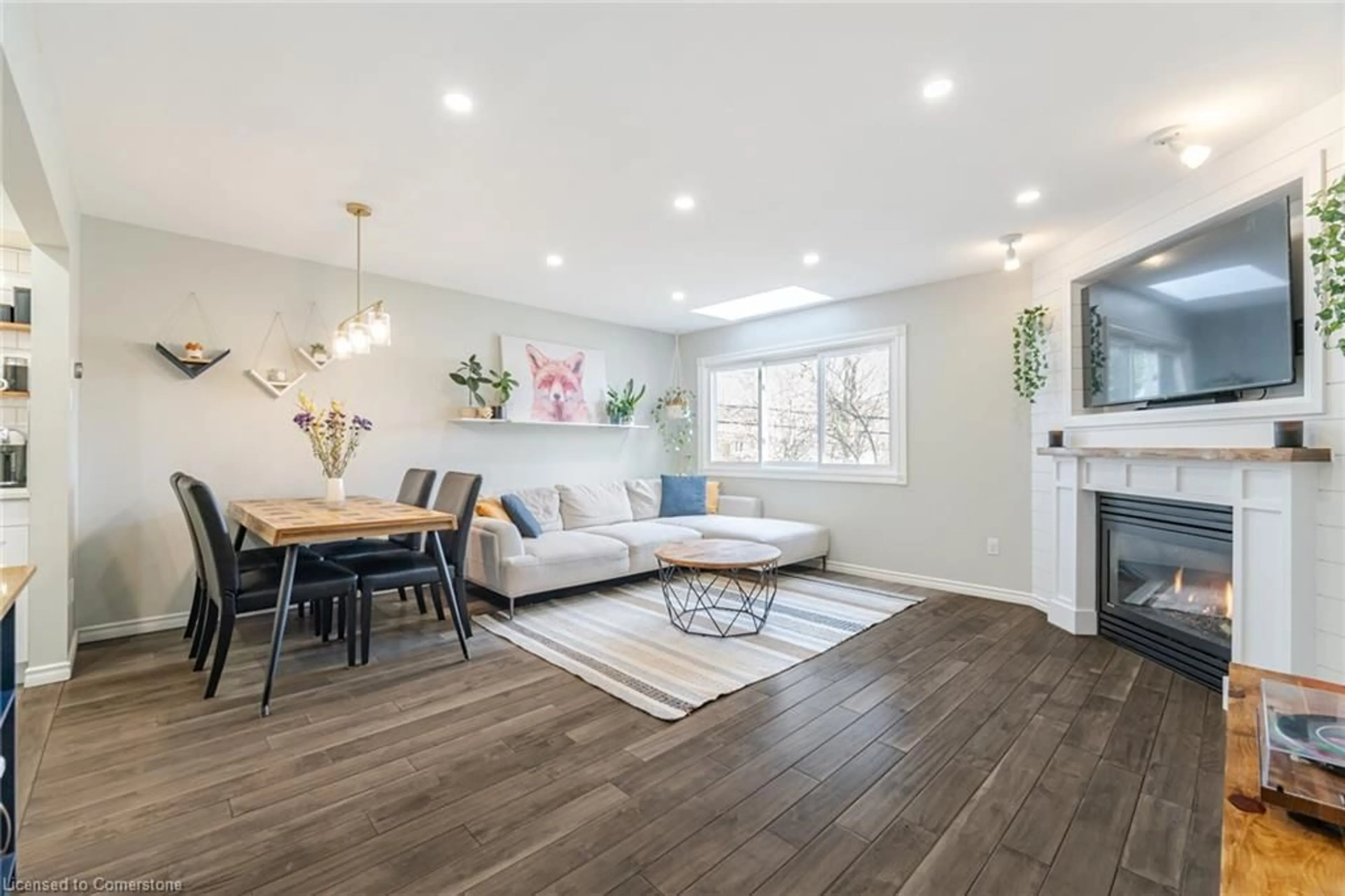 Living room with furniture, wood/laminate floor for 26 Moss Blvd #57, Hamilton Ontario L9H 6W8