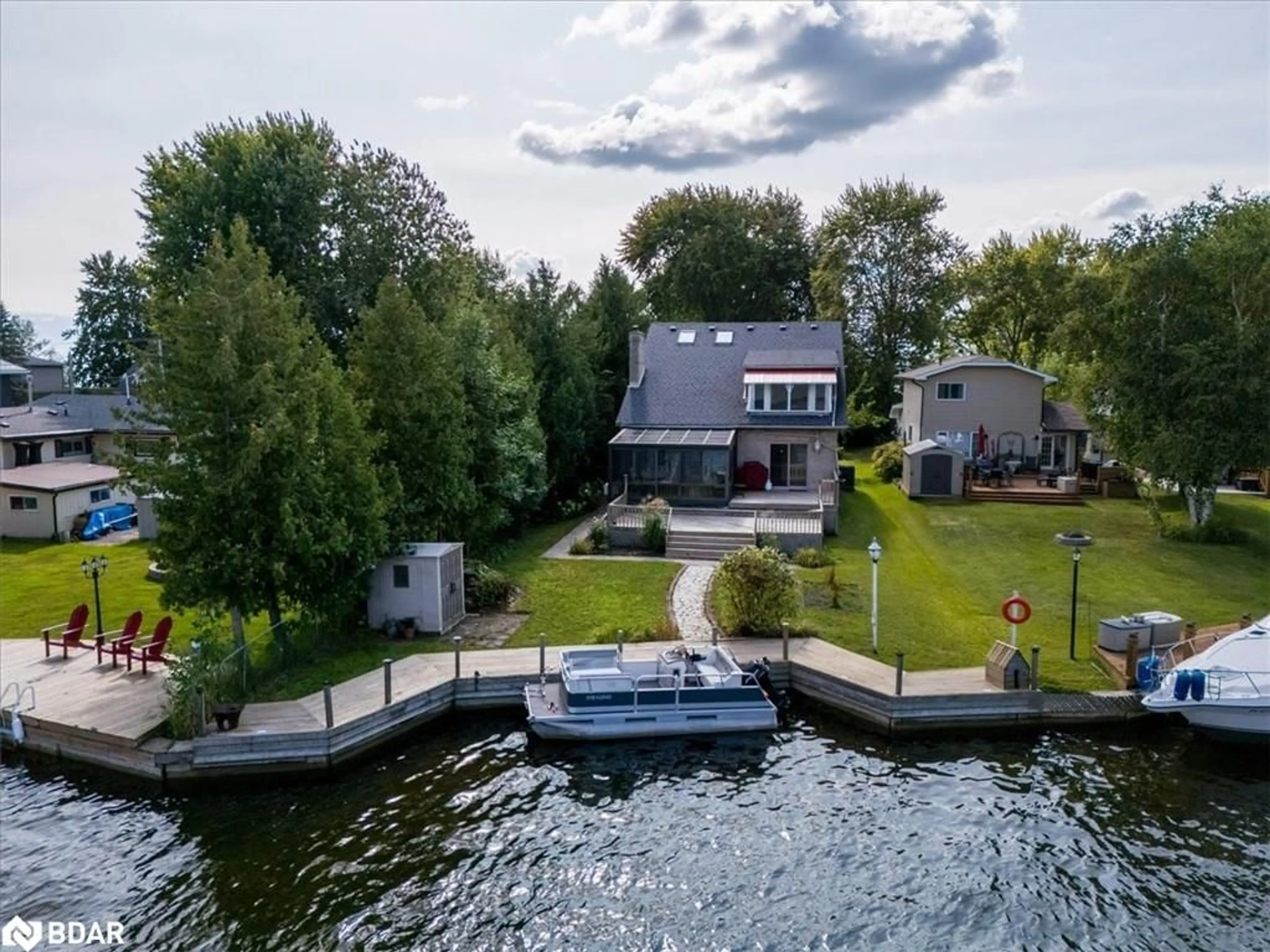 A pic from outside/outdoor area/front of a property/back of a property/a pic from drone, water/lake/river/ocean view for 57 Lake Ave, Ramara Ontario L0K 1B0