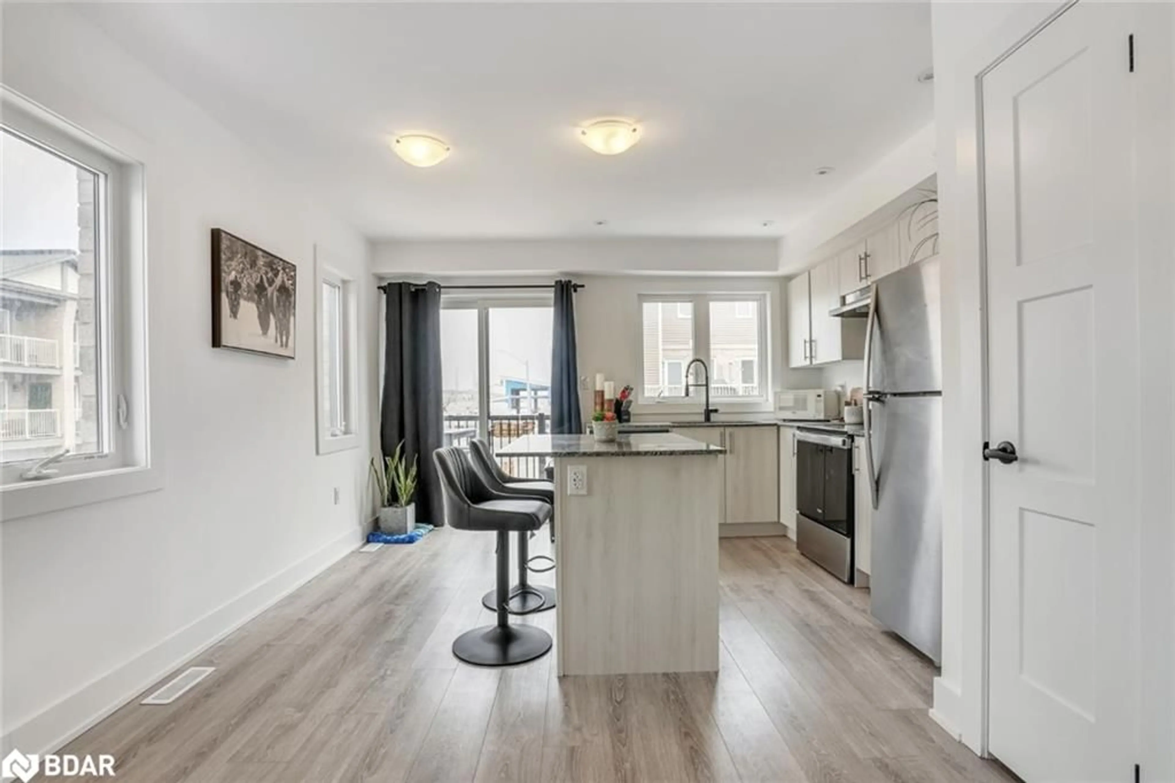 Open concept kitchen, wood/laminate floor for 30 Pumpkin Corner Crescent, Barrie Ontario L9J 0T6