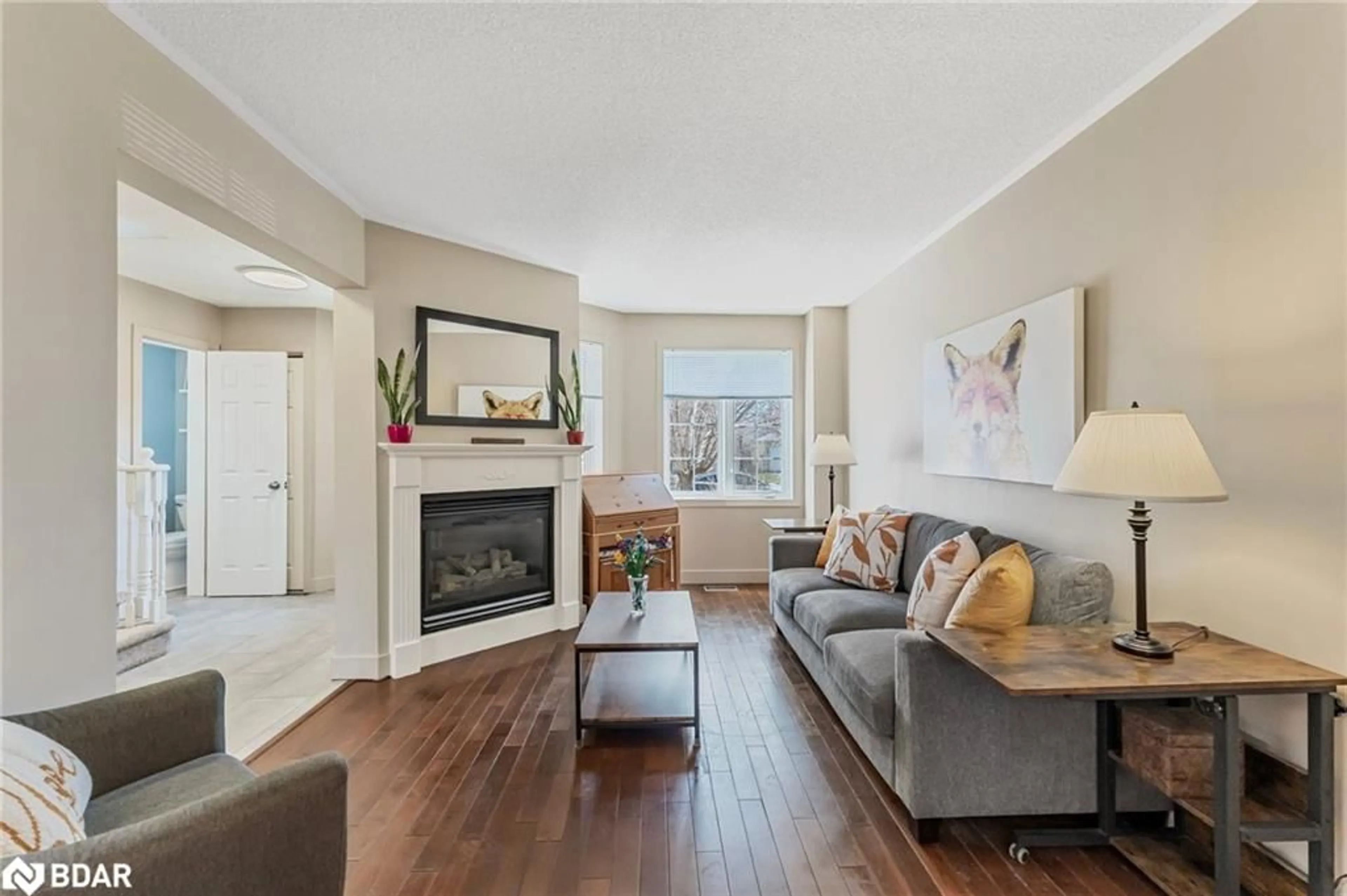 Living room with furniture, wood/laminate floor for 96 Churchland Dr, Barrie Ontario L4N 8P1