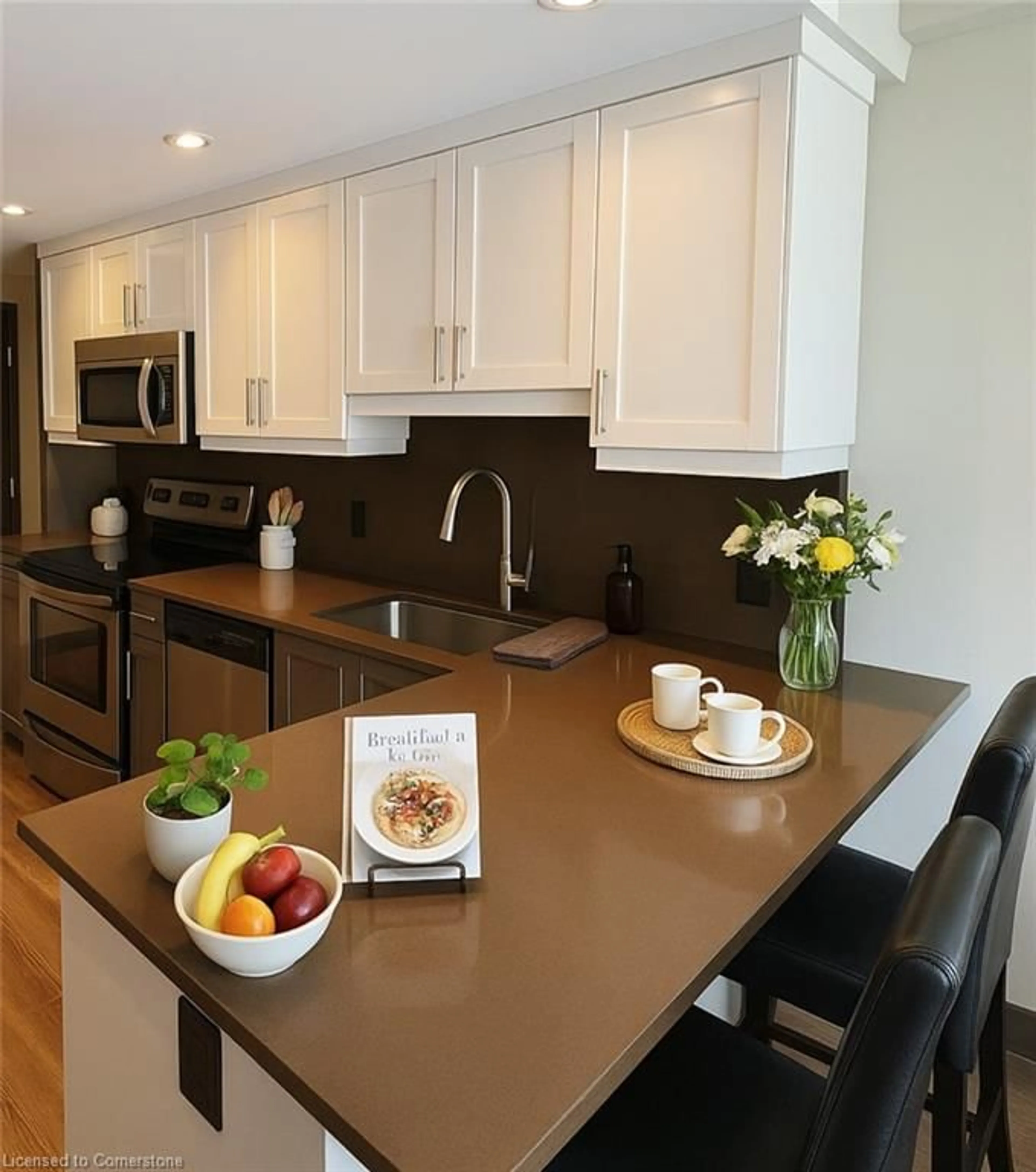 Open concept kitchen, wood/laminate floor for 330 Phillip St #C529, Waterloo Ontario N2L 3W9