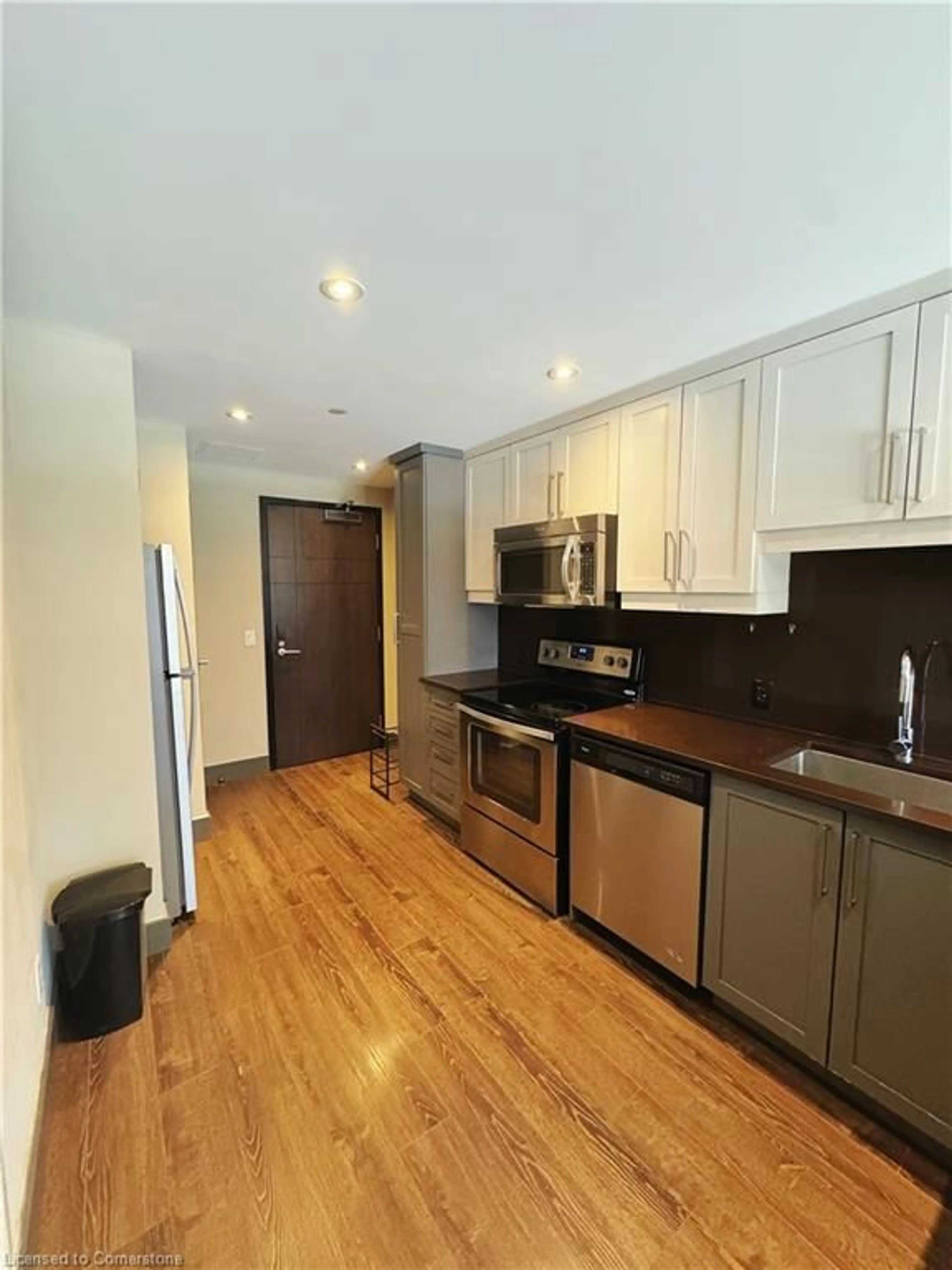 Open concept kitchen, wood/laminate floor for 330 Phillip St #C529, Waterloo Ontario N2L 3W9