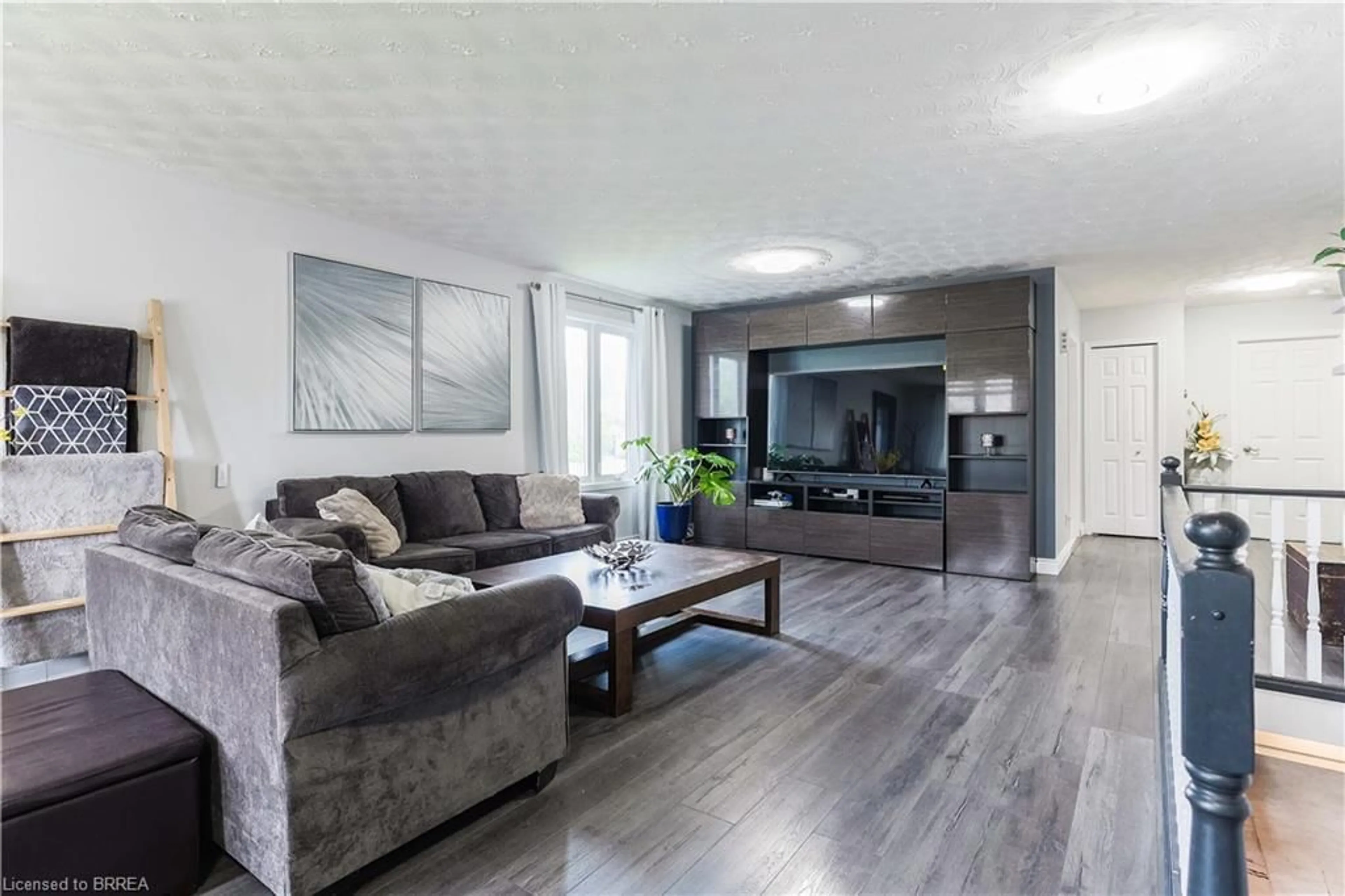 Living room with furniture, wood/laminate floor for 39 St Patricks Dr, Brantford Ontario N3T 6K9