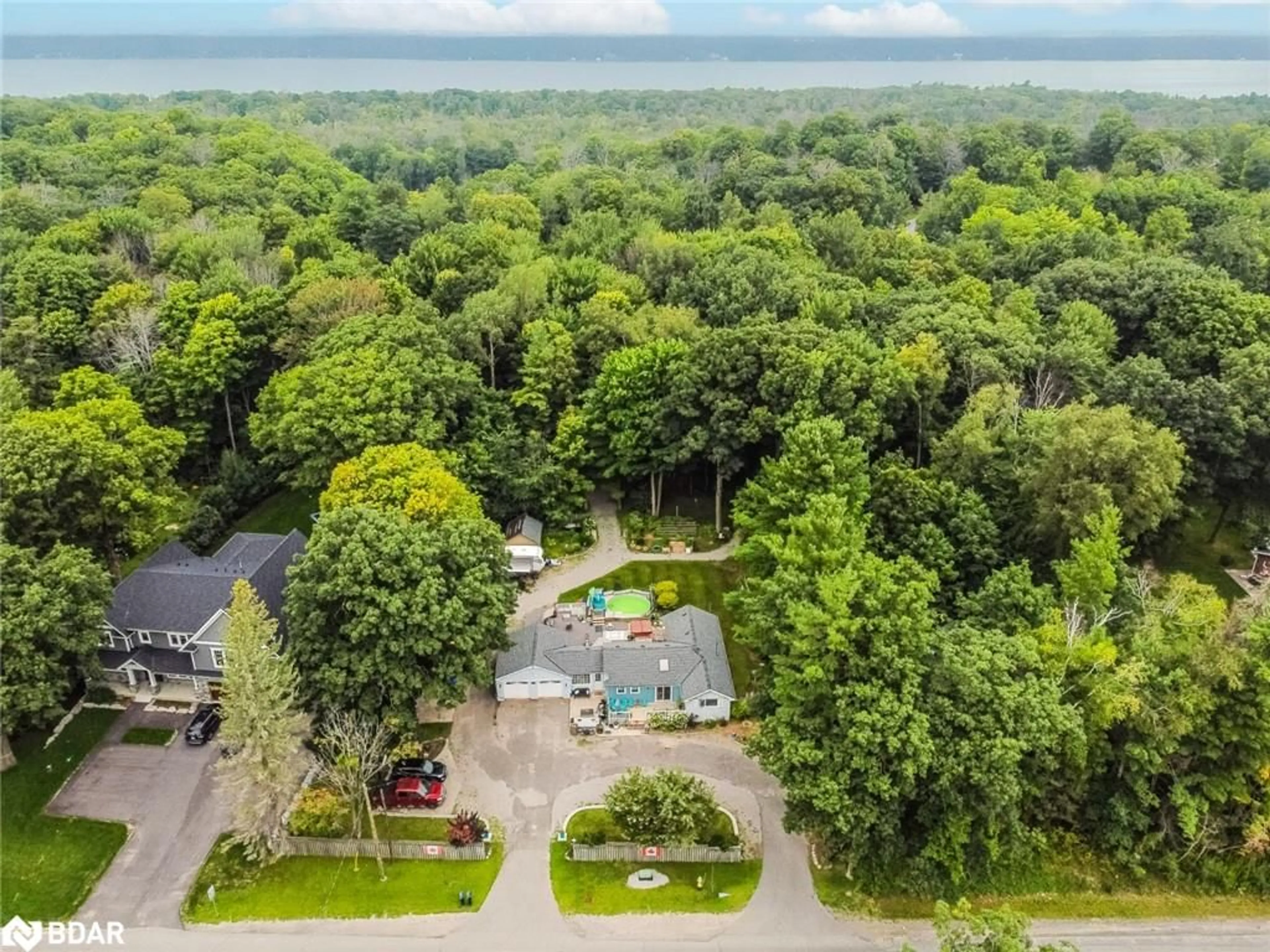 A pic from outside/outdoor area/front of a property/back of a property/a pic from drone, forest/trees view for 1776 Big Bay Point Rd, Innisfil Ontario L9S 2R4