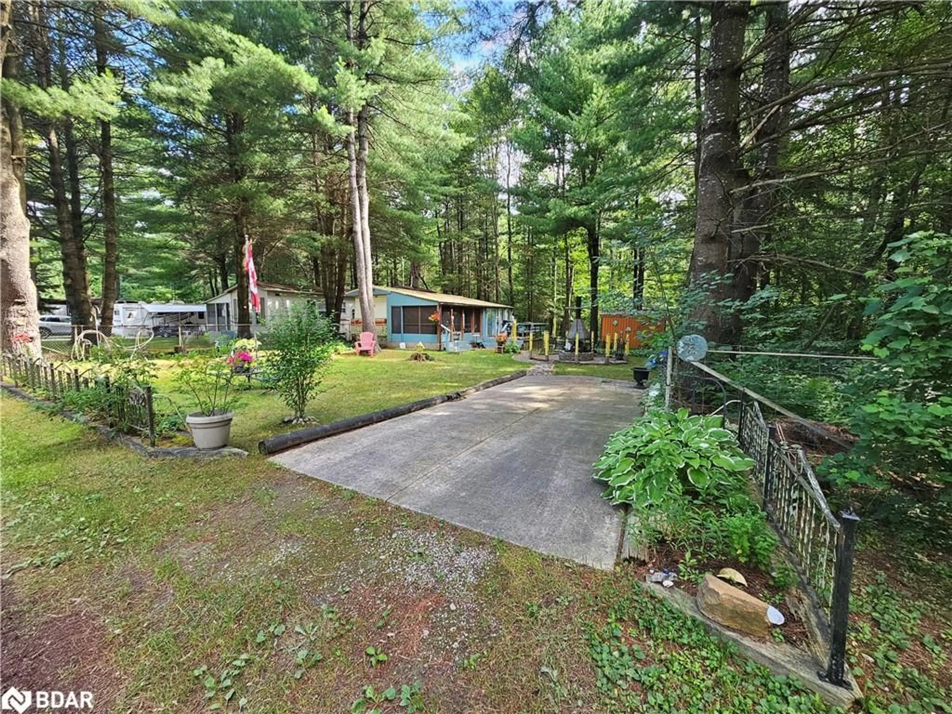A pic from outside/outdoor area/front of a property/back of a property/a pic from drone, forest/trees view for 5216 County Road 90 #92, Utopia Ontario L0M 1T2
