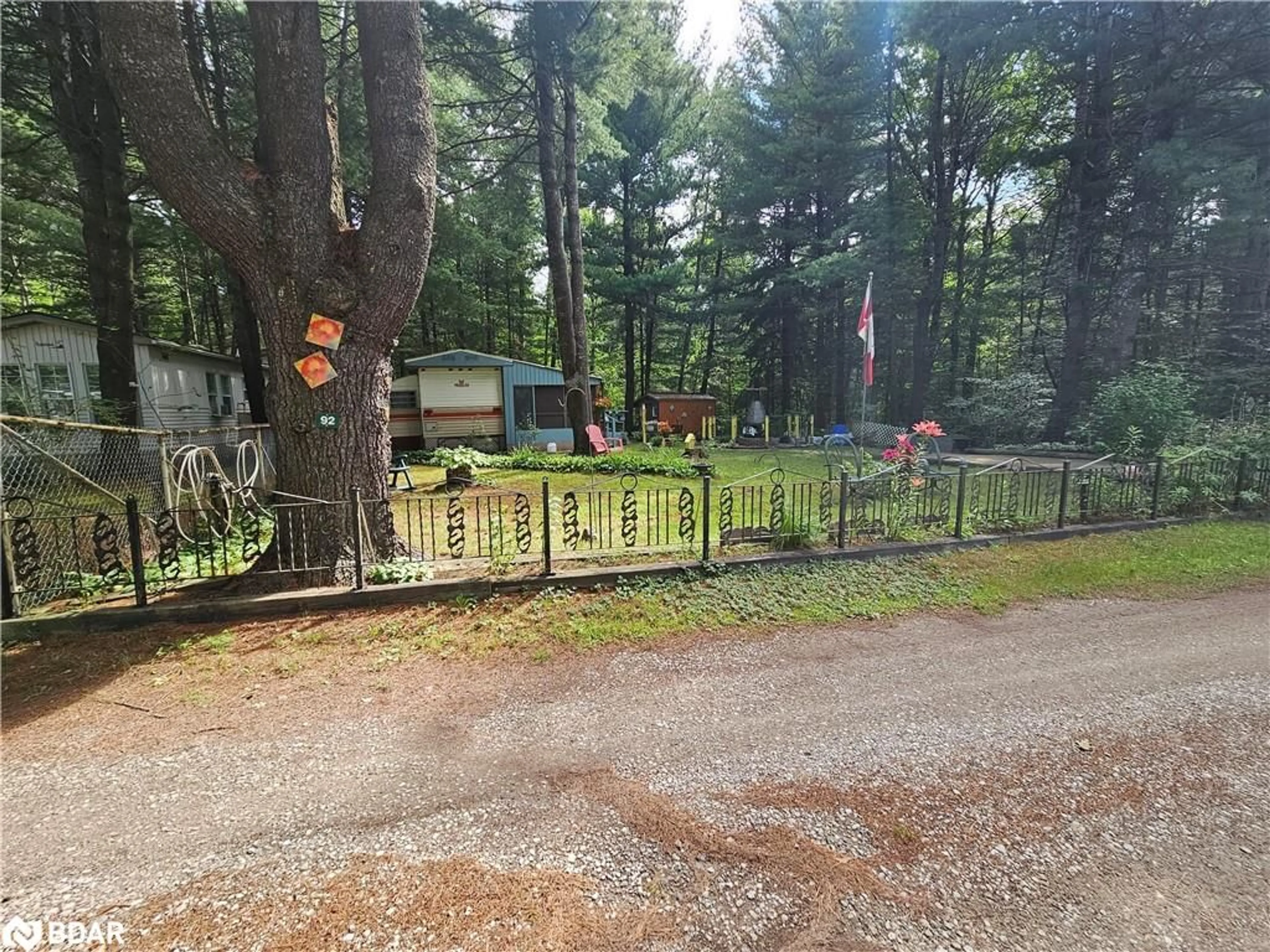 A pic from outside/outdoor area/front of a property/back of a property/a pic from drone, forest/trees view for 5216 County Road 90 #92, Utopia Ontario L0M 1T2