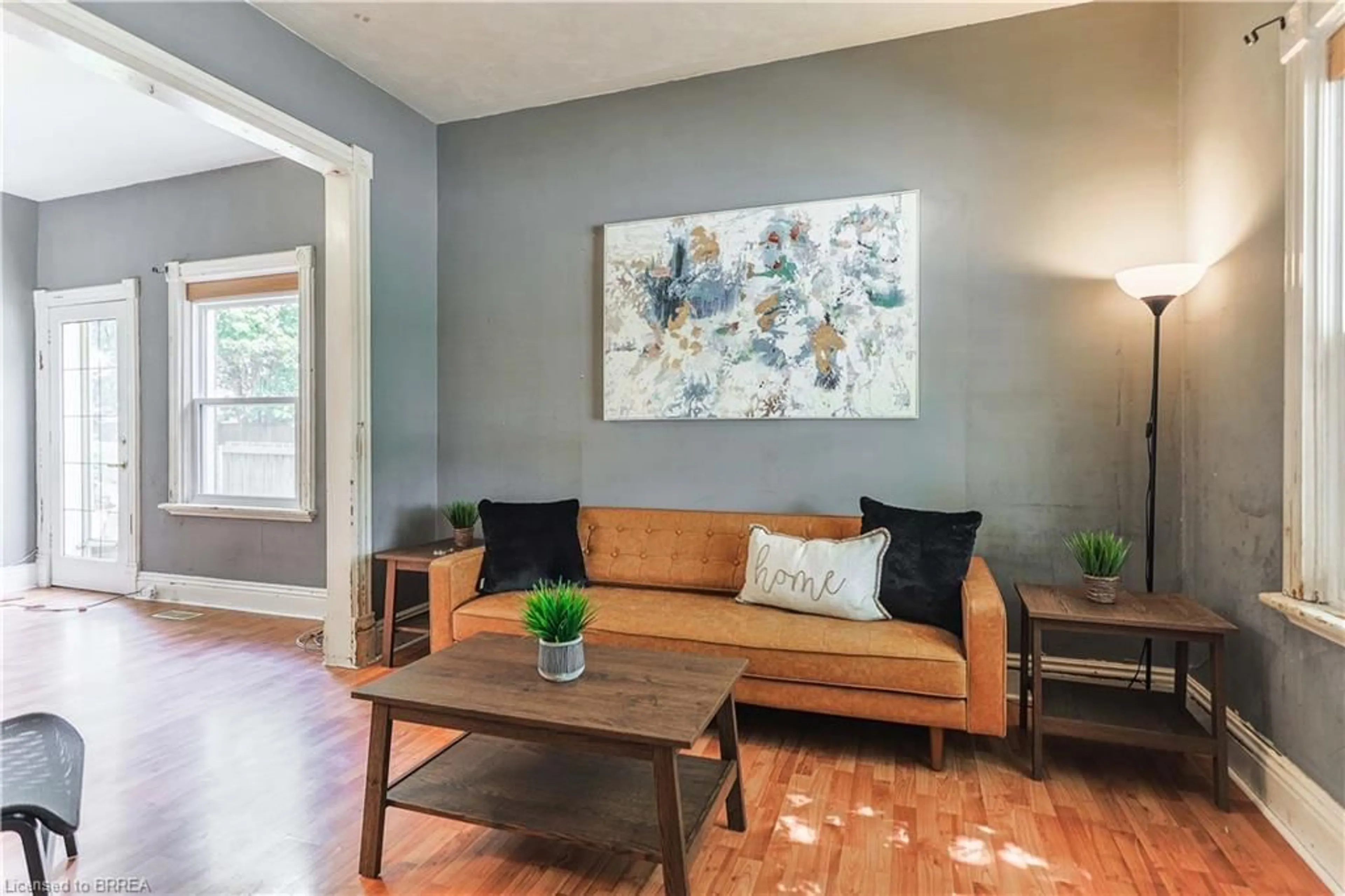 Living room with furniture, wood/laminate floor for 8 Main St, Brantford Ontario N3R 3X2