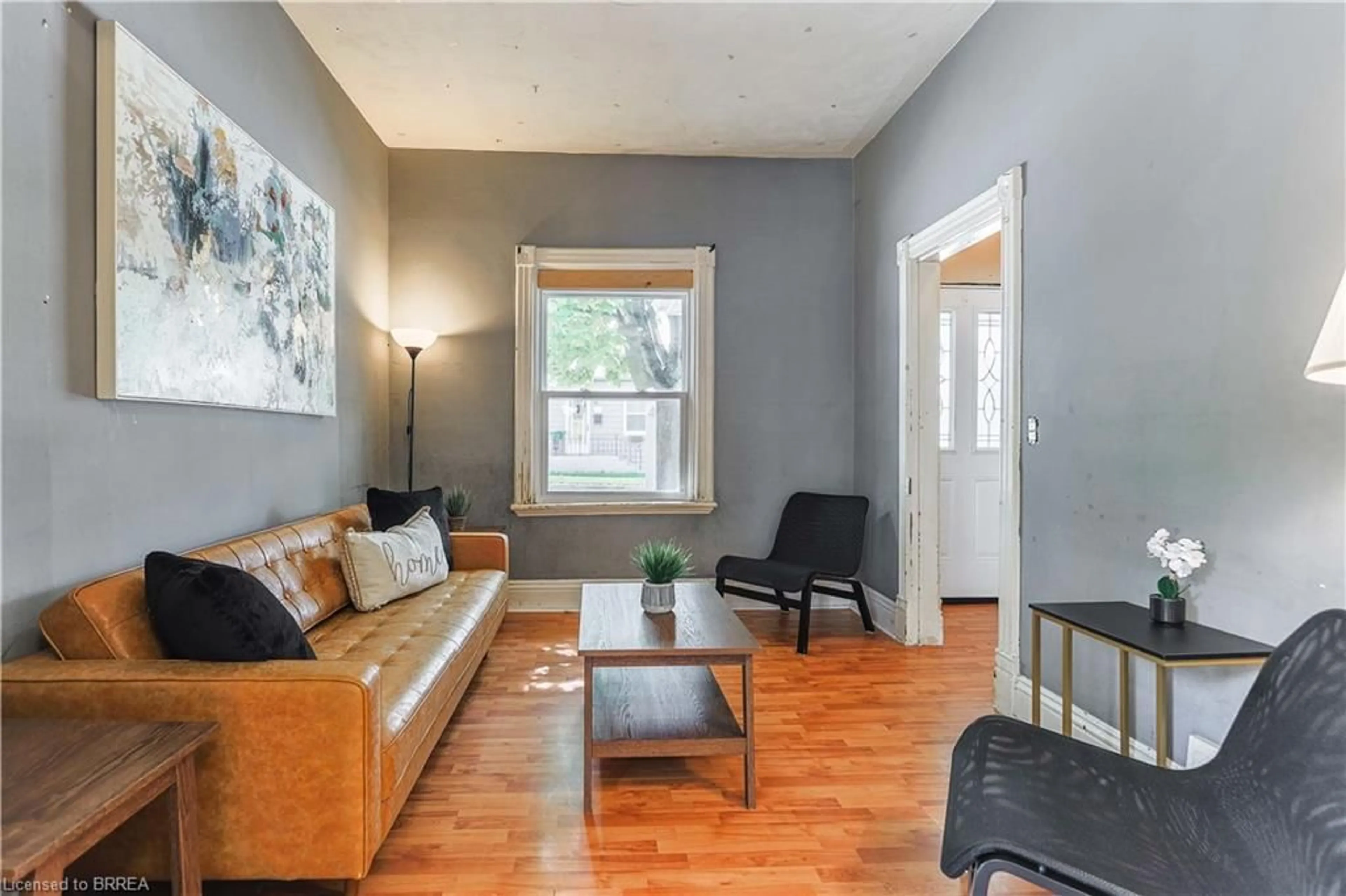 Living room with furniture, wood/laminate floor for 8 Main St, Brantford Ontario N3R 3X2