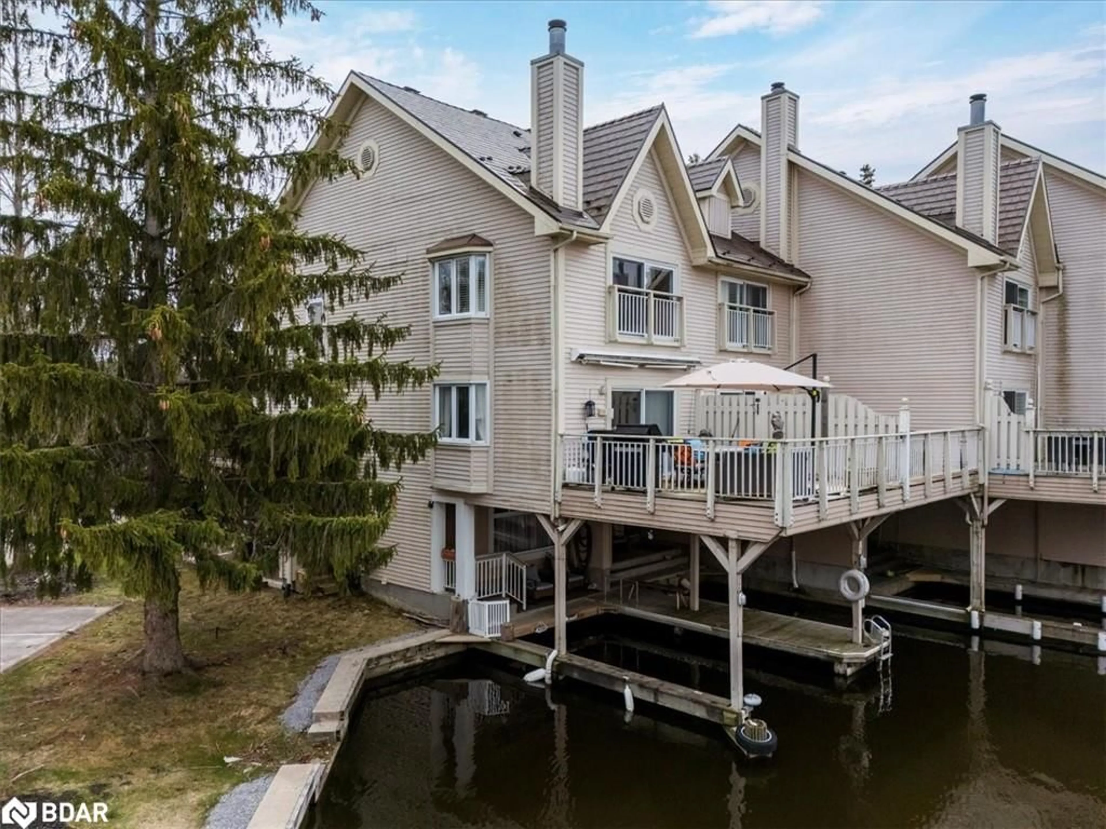 A pic from outside/outdoor area/front of a property/back of a property/a pic from drone, water/lake/river/ocean view for 100 Laguna Pky Pky #8, Brechin Ontario L0K 1B0